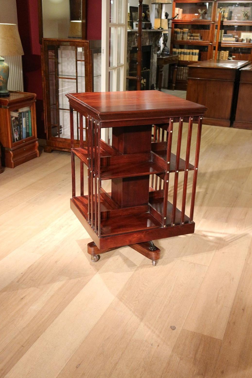 Beautiful large mahogany book mill in perfect condition. It is a very solid book mill with a cast iron base. Made circa 1900 by the company Maple & Co. Beautiful warm color. Size: 60cm x 60cm x H 94cm The maker Maple & Co was the most important