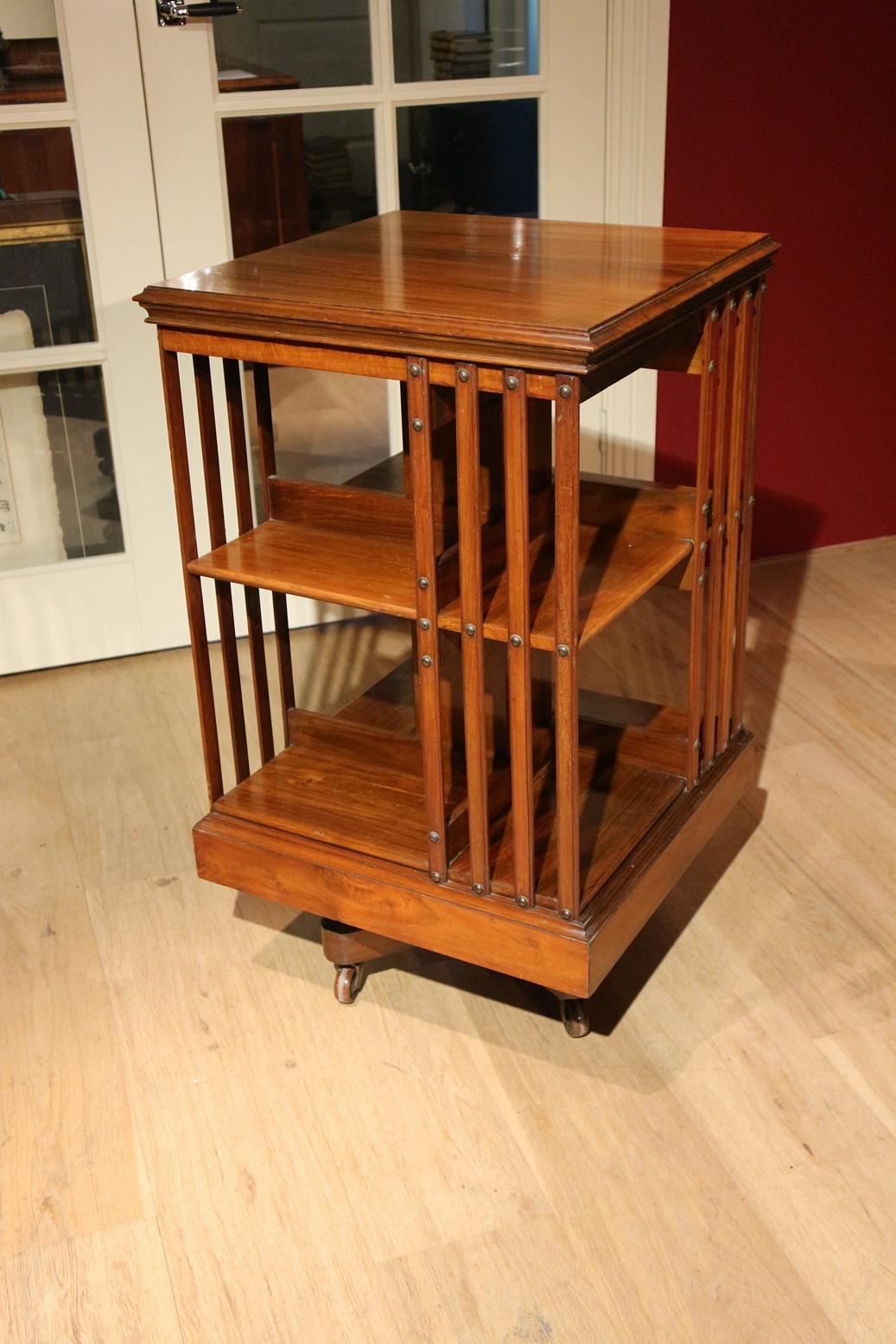 Beautiful antique walnut revolving bookcase. Superb quality revolving bookcase of the famous 19th century English furniture maker Maple & Co. with the typical cast iron base. Very stabile and solid revolving bookcase. Nice color and