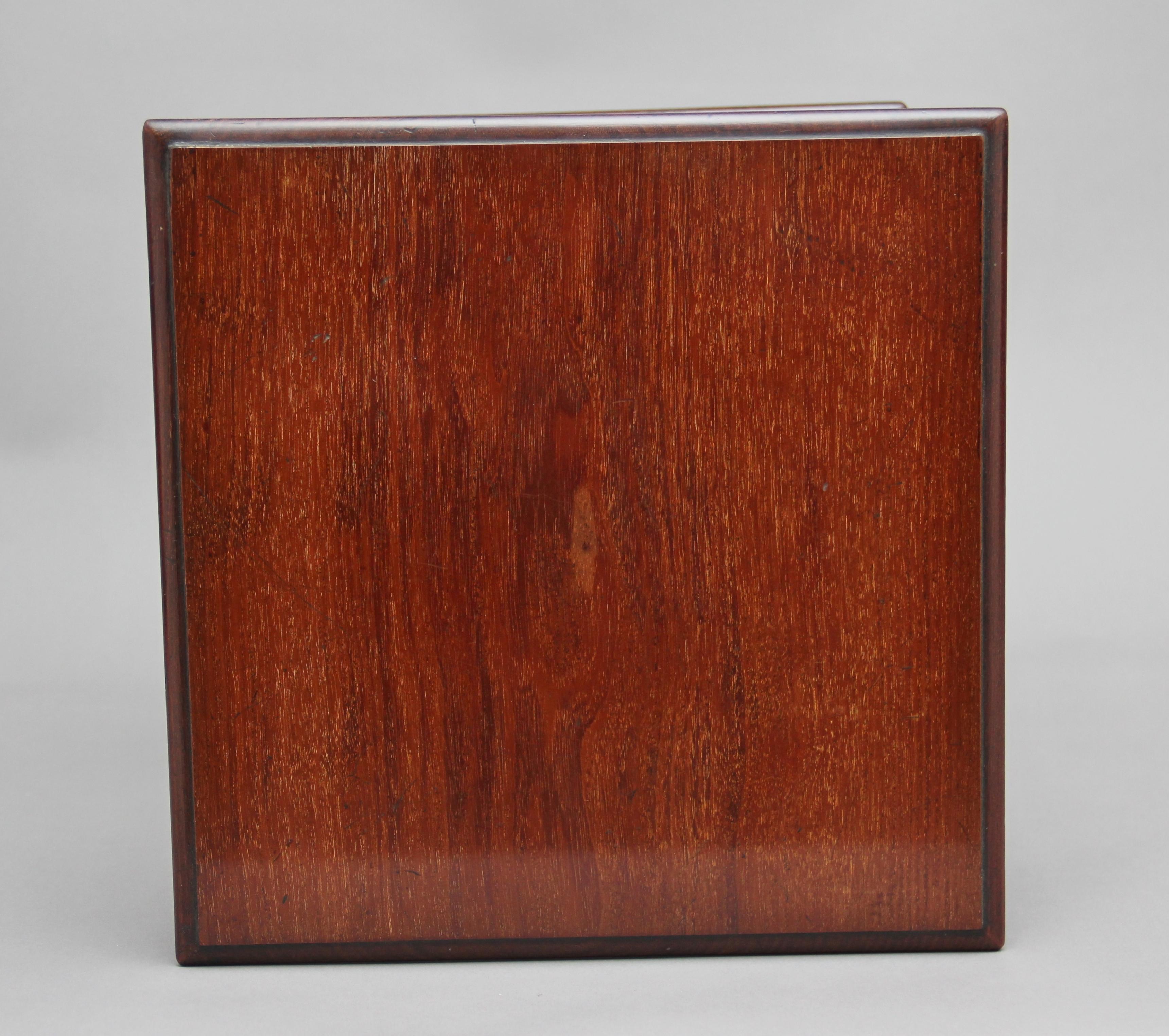 19th century mahogany revolving bookstand / bookcase, the moulded edge top and bottom section supported by a central turned column with various spindle dividers running along the outside, standing on a circular revolving mechanism, circa