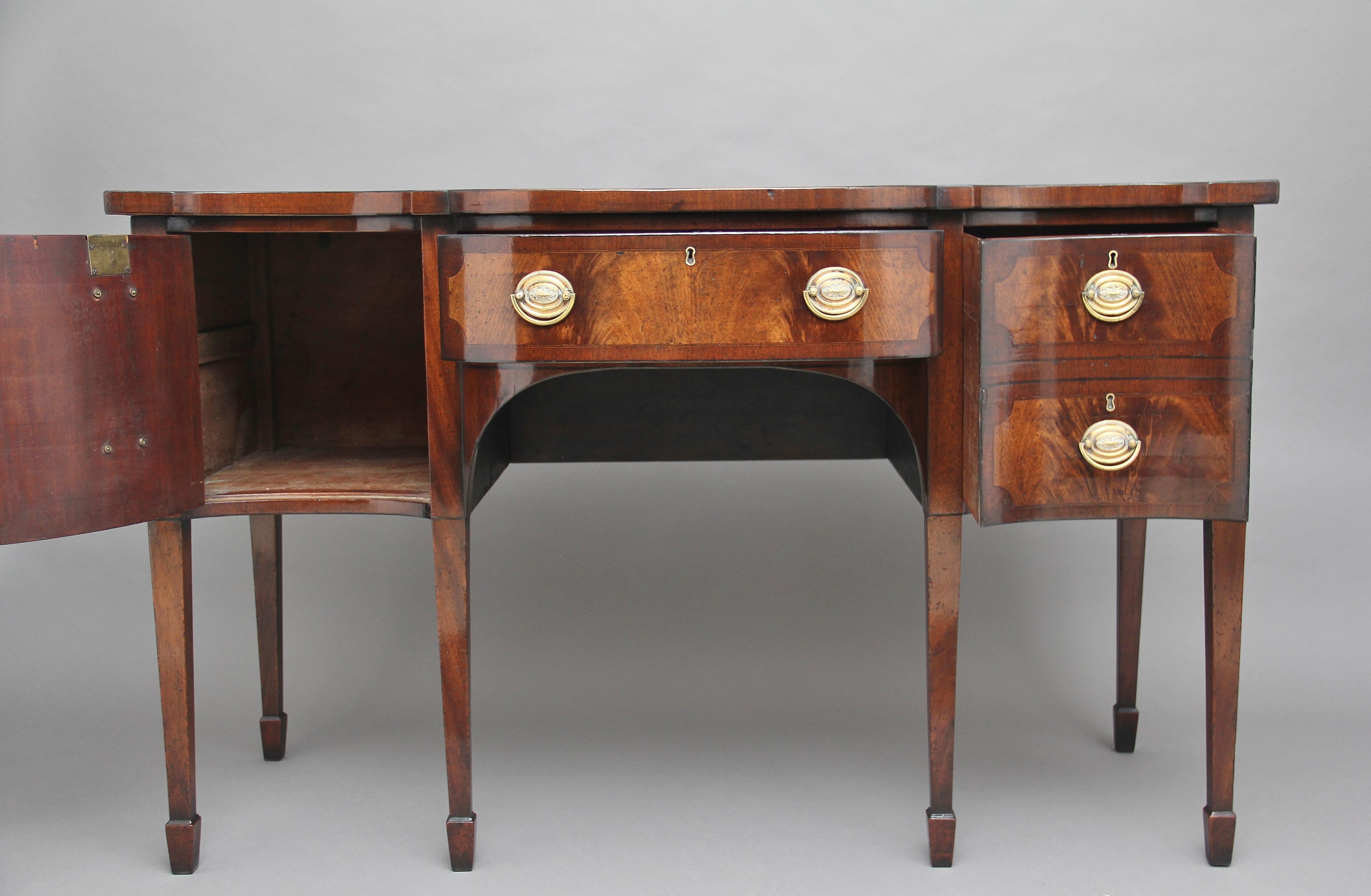 19th century mahogany sideboard of serpentine form, having a lovely shaped figured top crossbanded around the edge and inlaid with boxwood lines, with a drawer at the centre, to the left is a cupboard with a hinged door and a deep drawer to the
