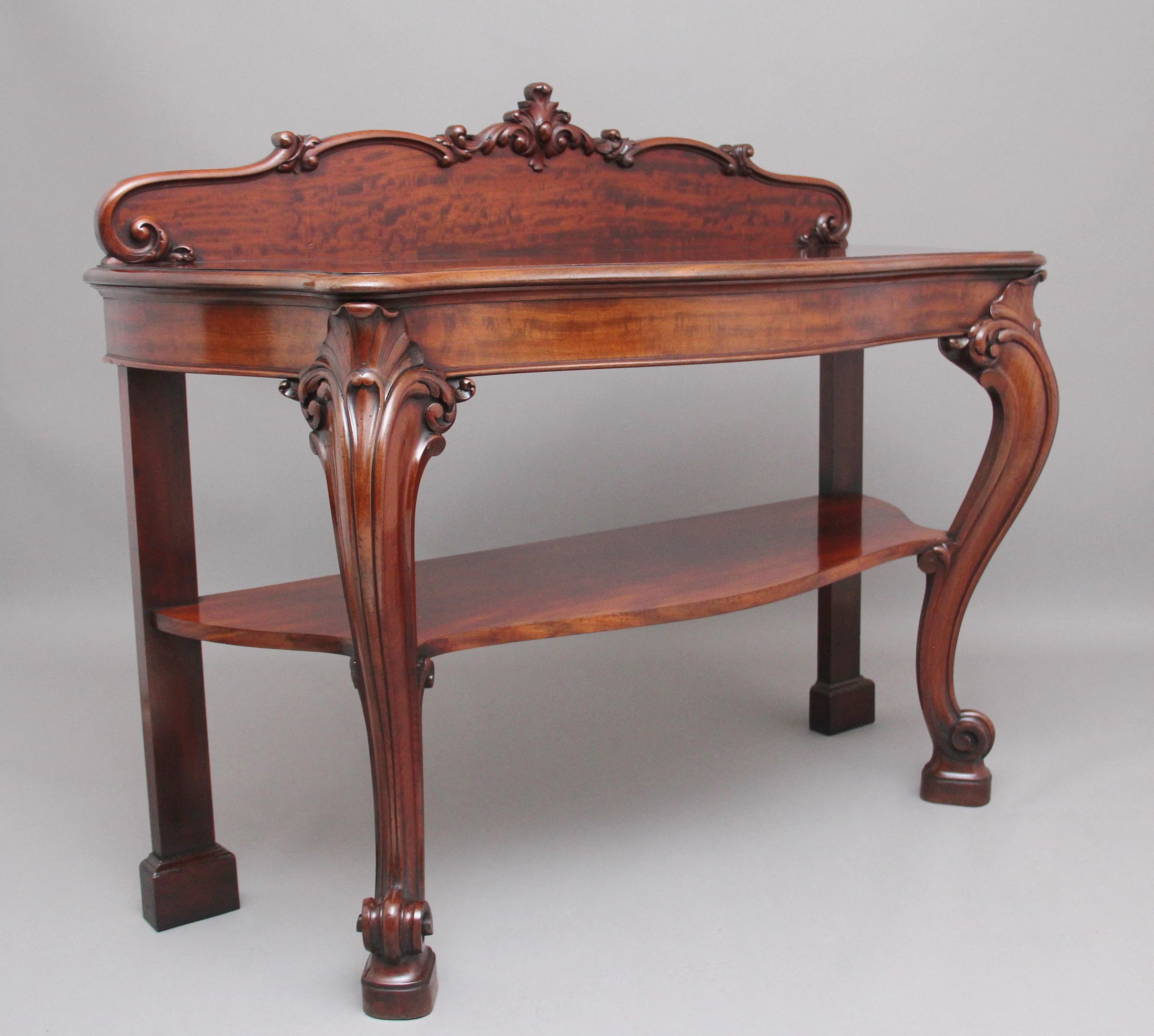 A lovely quality 19th century mahogany serving table with a rectangular shaped top with a thumb moulded edge, shaped and carved back with lovely figuration, supported on elegant shaped cabriole legs decorated with lovely crisp carving terminating on
