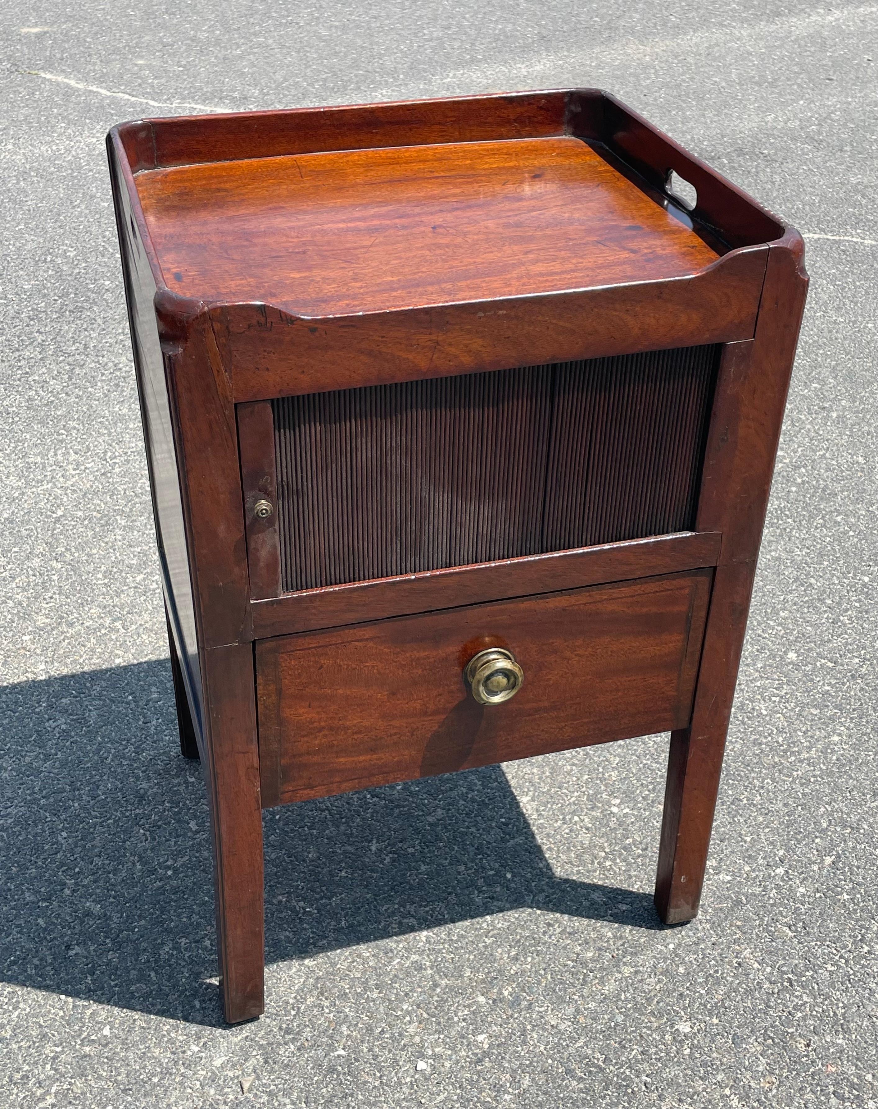 19th century Mahogany sewing stand or work table.  Upper three-sided gallery top with finger cutouts on sides above storage compartment with accordion style sliding door, with single drawer below.  Brass knobs.  Surface height 28.5 inches.