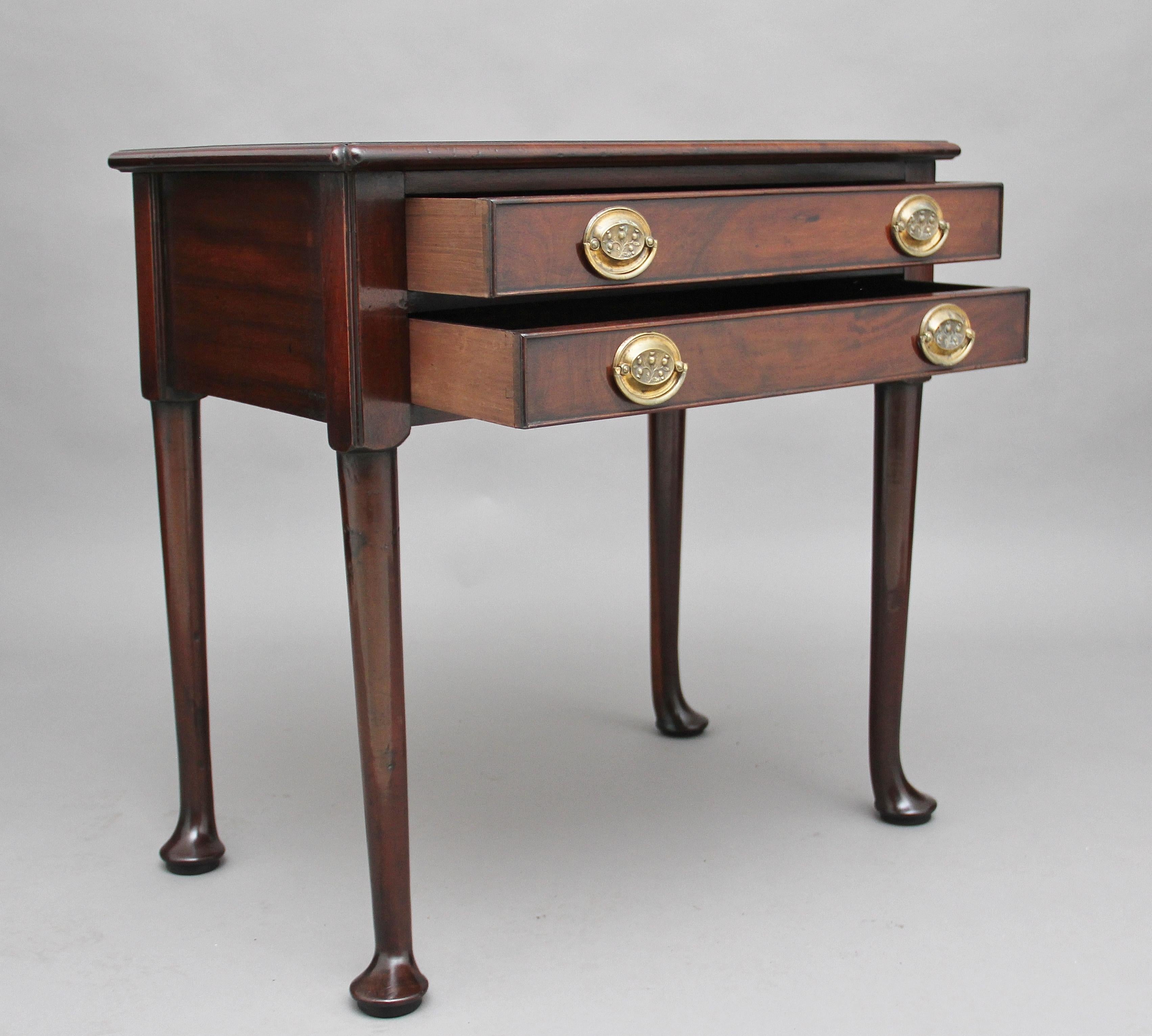 19th century mahogany side table, the rectangular shaped top having a thumb moulded edge above two drawers with original brass oval plate handles, supported on turned legs terminating on a pad foot. Fantastic color and in great condition, circa