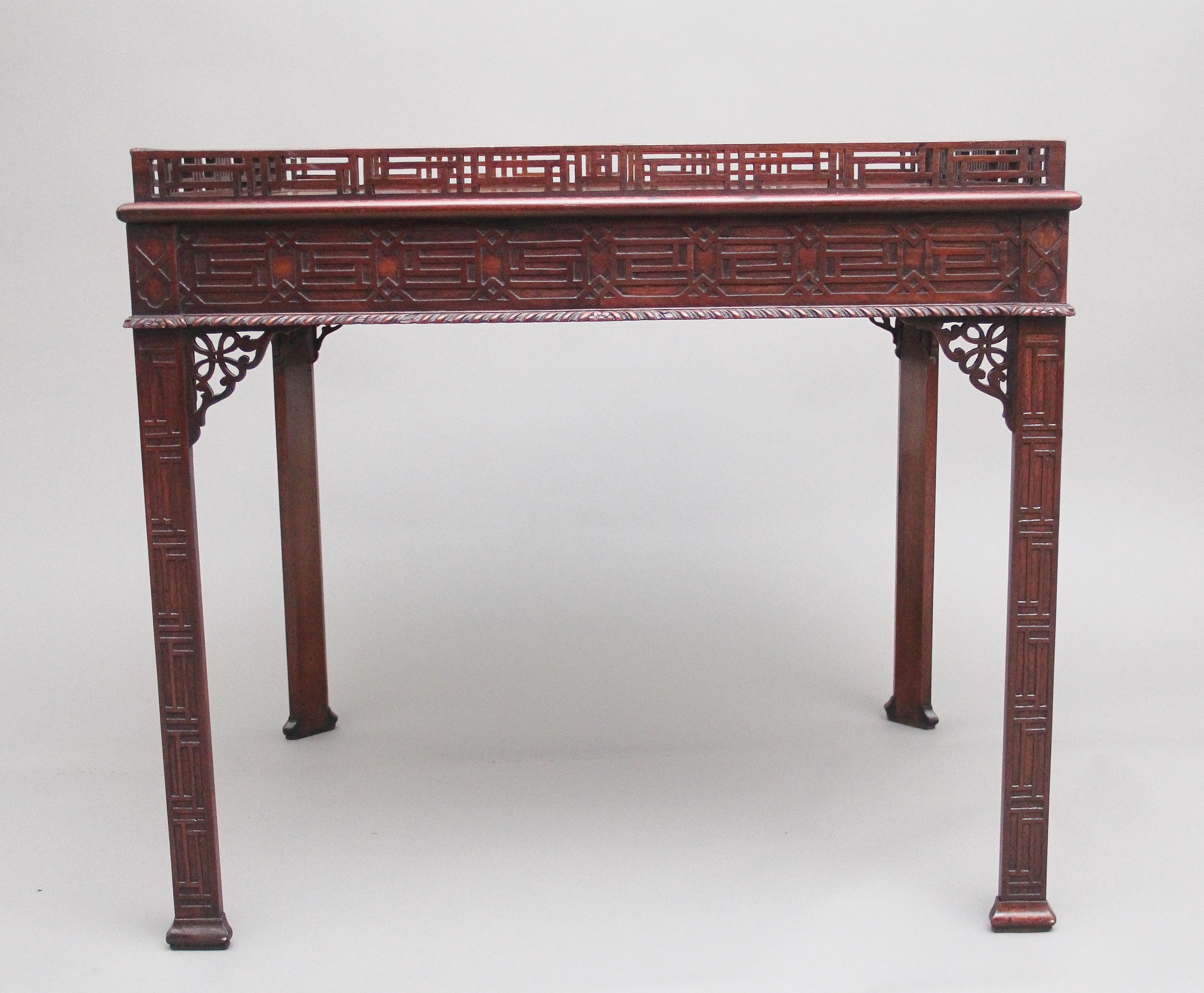 19th century Mahogany silver / occasional table in the Chinese Chippendale style, having a nice figured top with a decorative pierced fret gallery, the frieze below having decorative blind fret carving on all sides, pierced fret corner brackets,