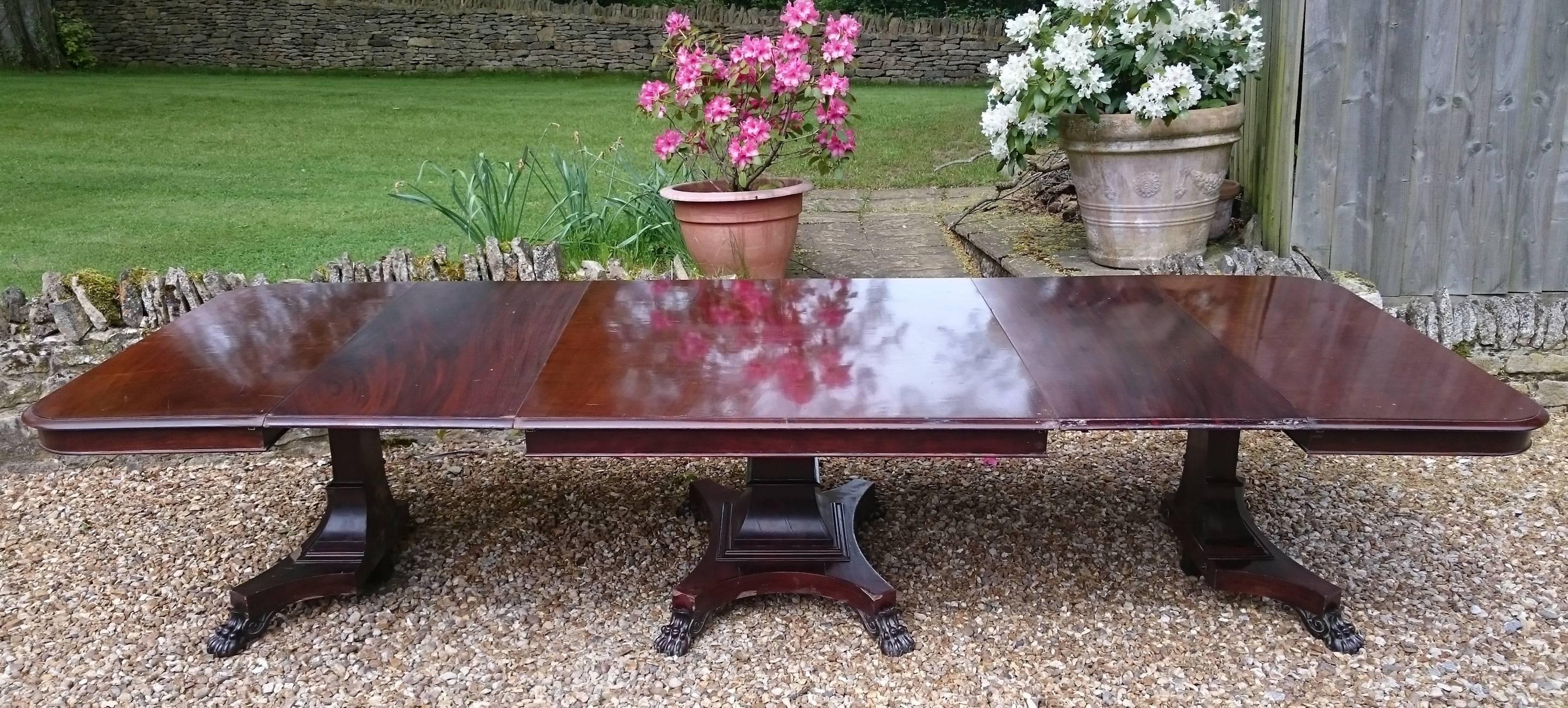 19th century three pedestal antique dining table with two removable leaves. This is a very finely constructed dining table and it is made from a choice cut of mahogany. This is a very flexible table as the two end tables have the ability to be put