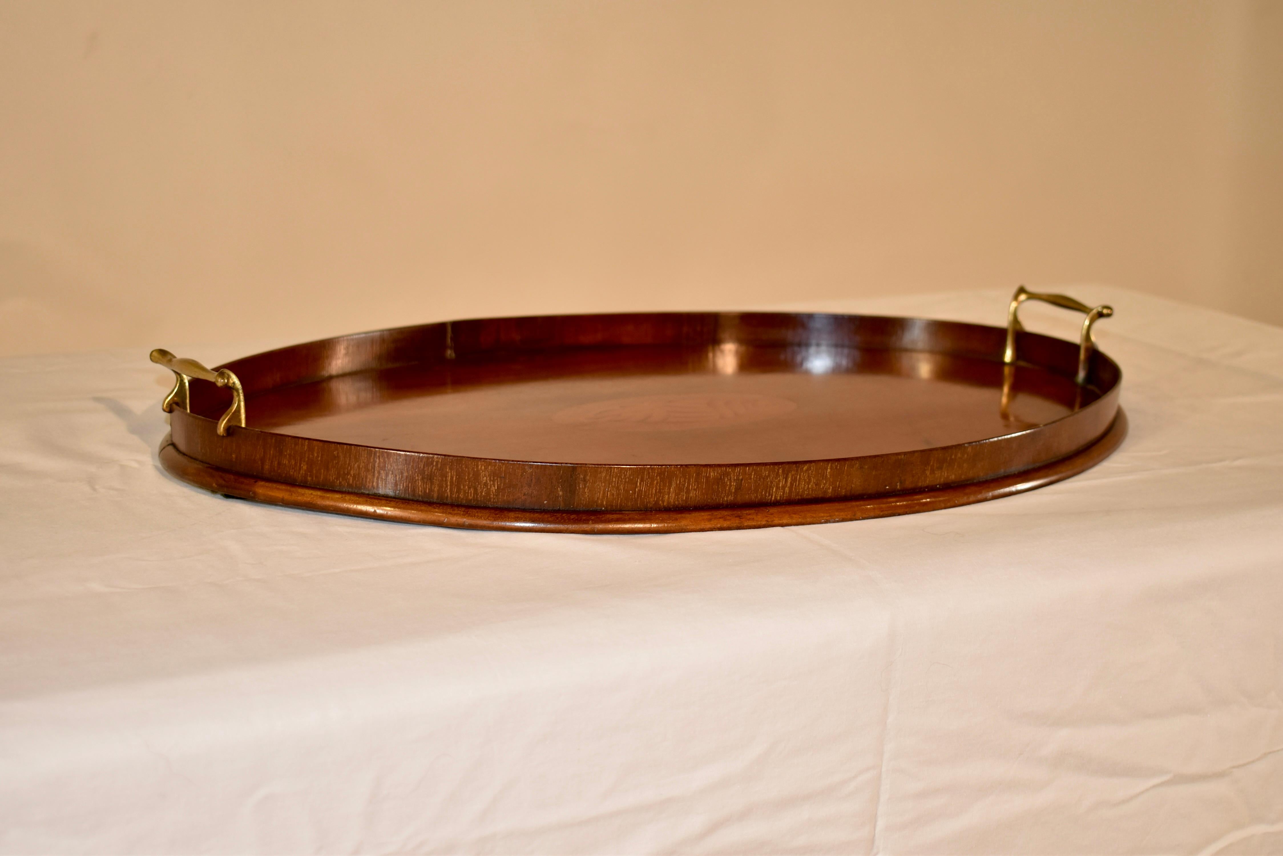 Early 19th century mahogany tray from England with a gallery surrounding the tray, which has a central lozenge with an inlaid shell made from satinwood and boxwood. Lovely graining and color.