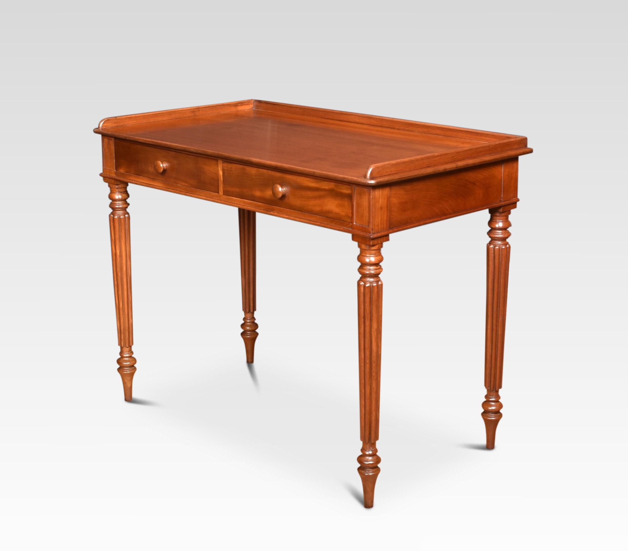 19th century writing table, having a large mahogany top with raised three-quarter gallery above two frieze drawers with turned knobs. All raised up on turned tapered reeded legs.
Dimensions:
Height 31.5 Inches
Width 40 Inches
Depth 22 Inches.