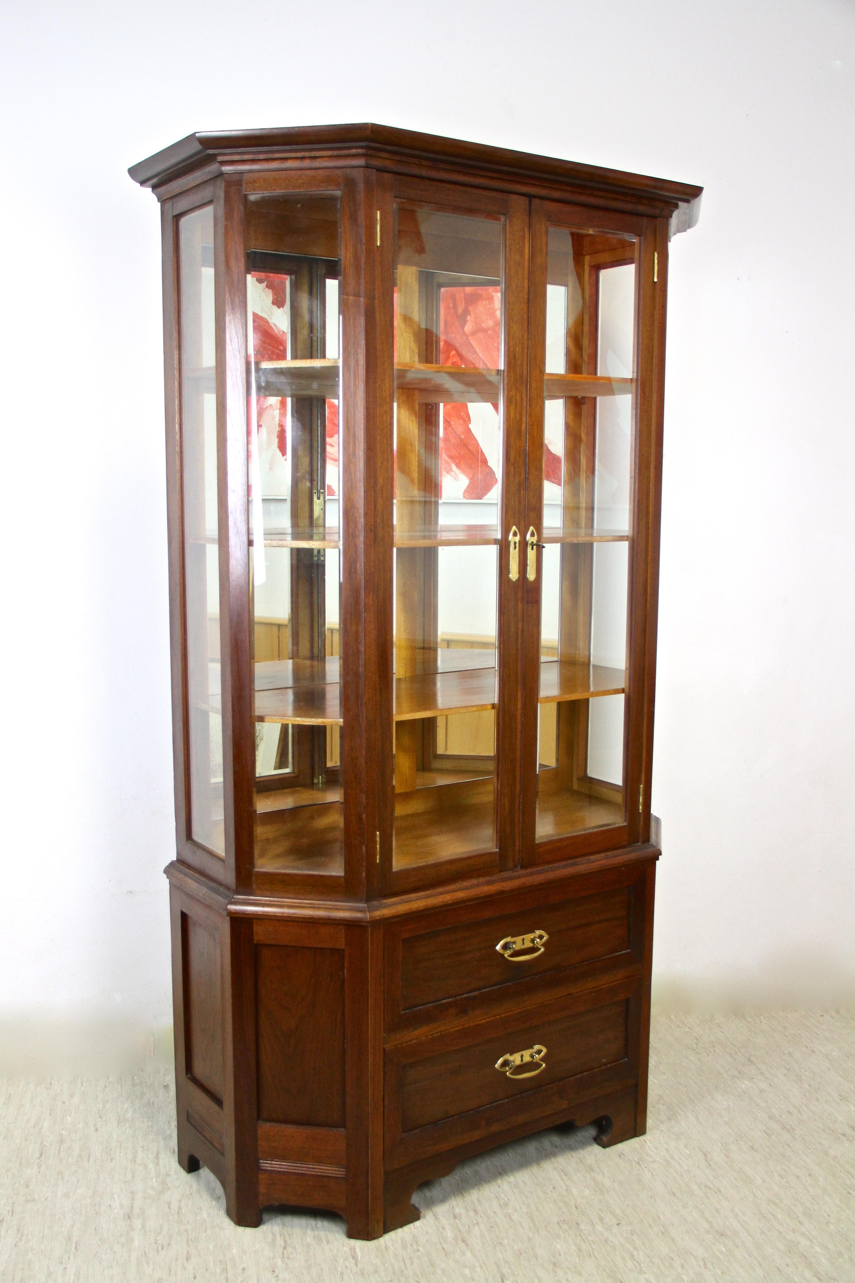Fantastic Mahogany Vitrine Cabinet from the early 20th century with the still original faceted glass panels. An absolute beautiful designed Art Nouveau Vitrine elaborately made in Austria around 1910 with two doors that can be wide opened, offering