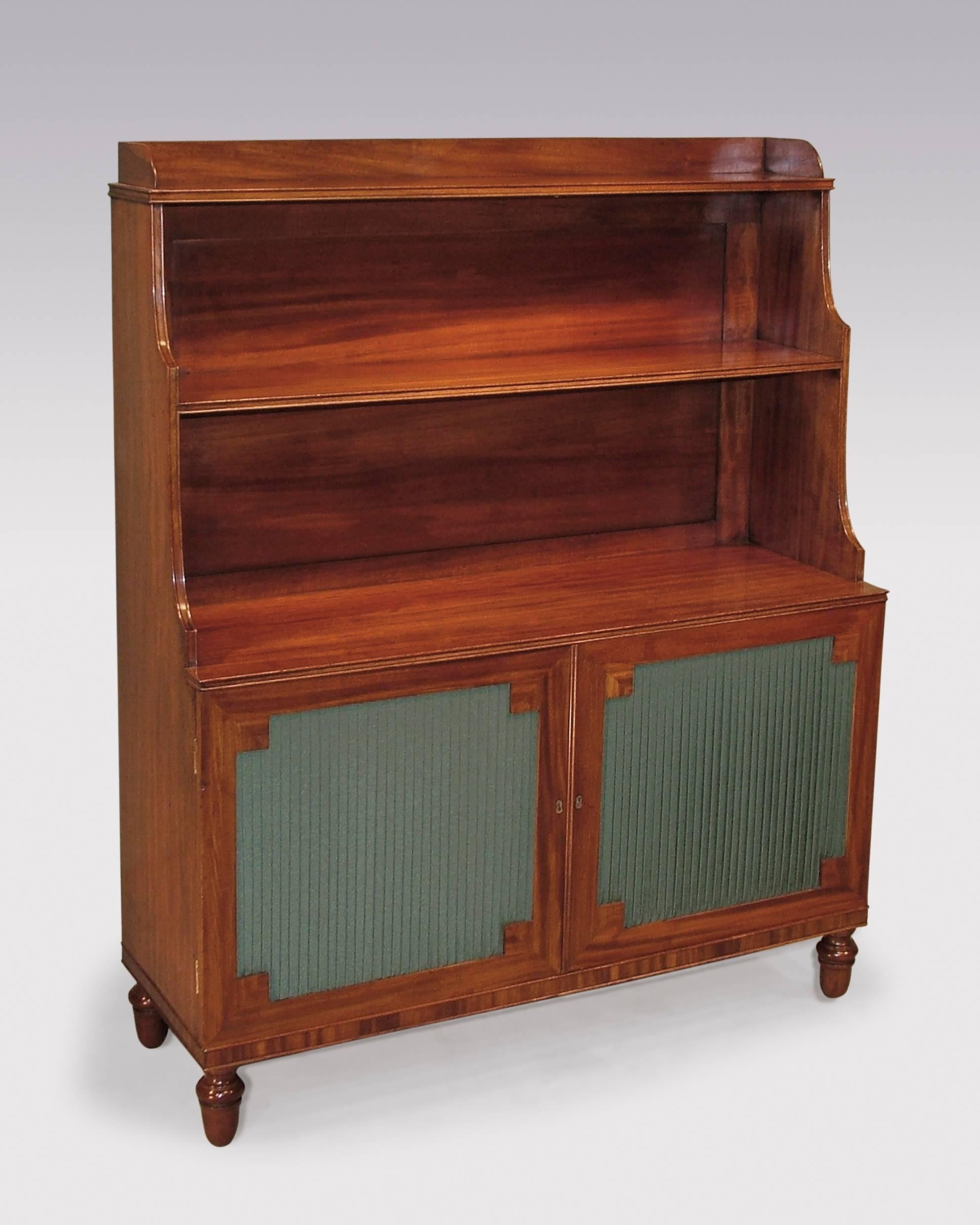 A pair of early 19th century Regency period well figured mahogany waterfall bookshelves, having galleried tops above beaded edged graduated shelves, above pleated panelled doors with mitred corners, supported on turned acorn feet.