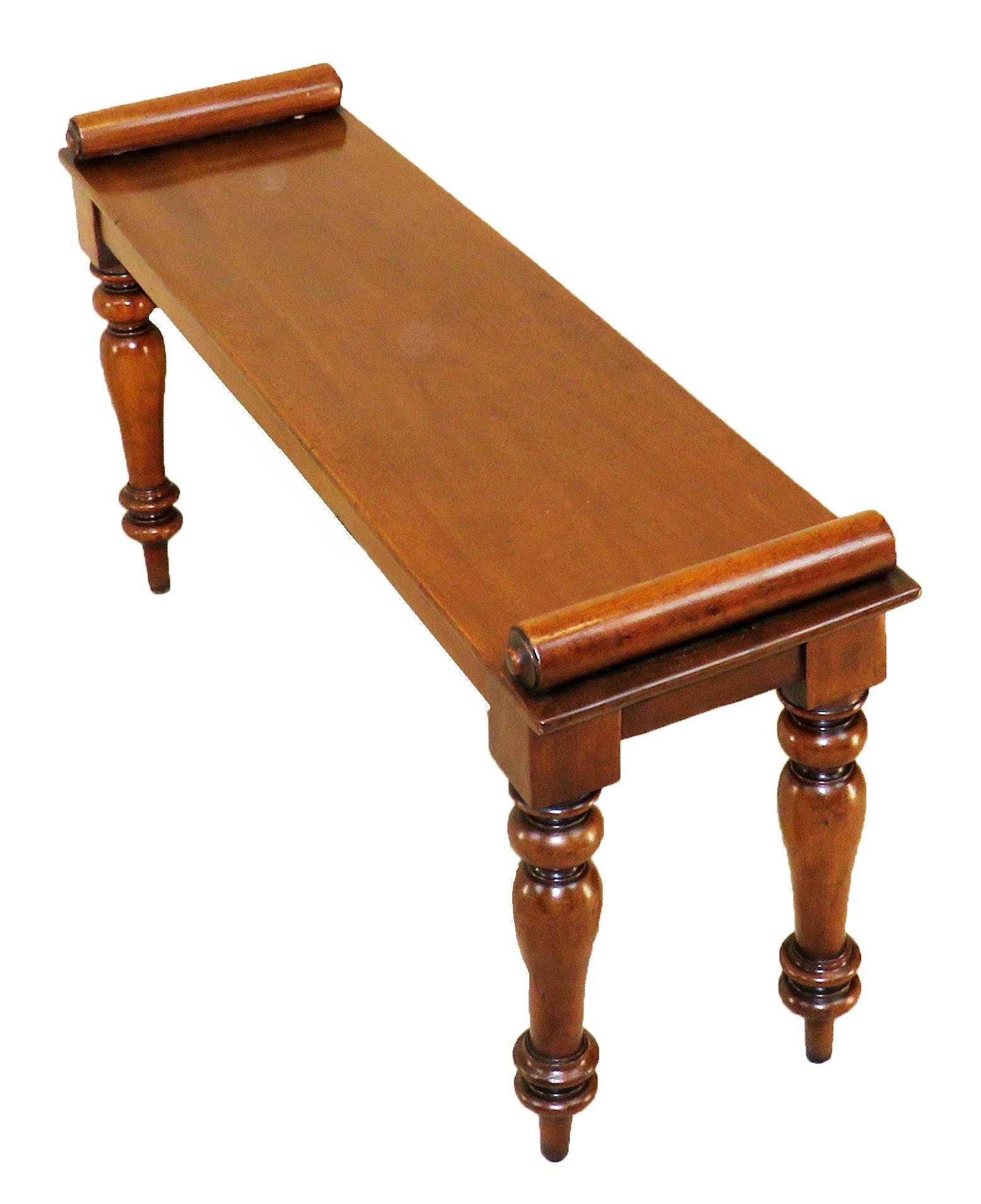 A mid-19th century mahogany window seat hall
Bench having applied turned rolls to top raised
On elegant turned legs

(These benches often follow a fairly typical design. This particular 
example is of good, functional size and is sturdy, so fit