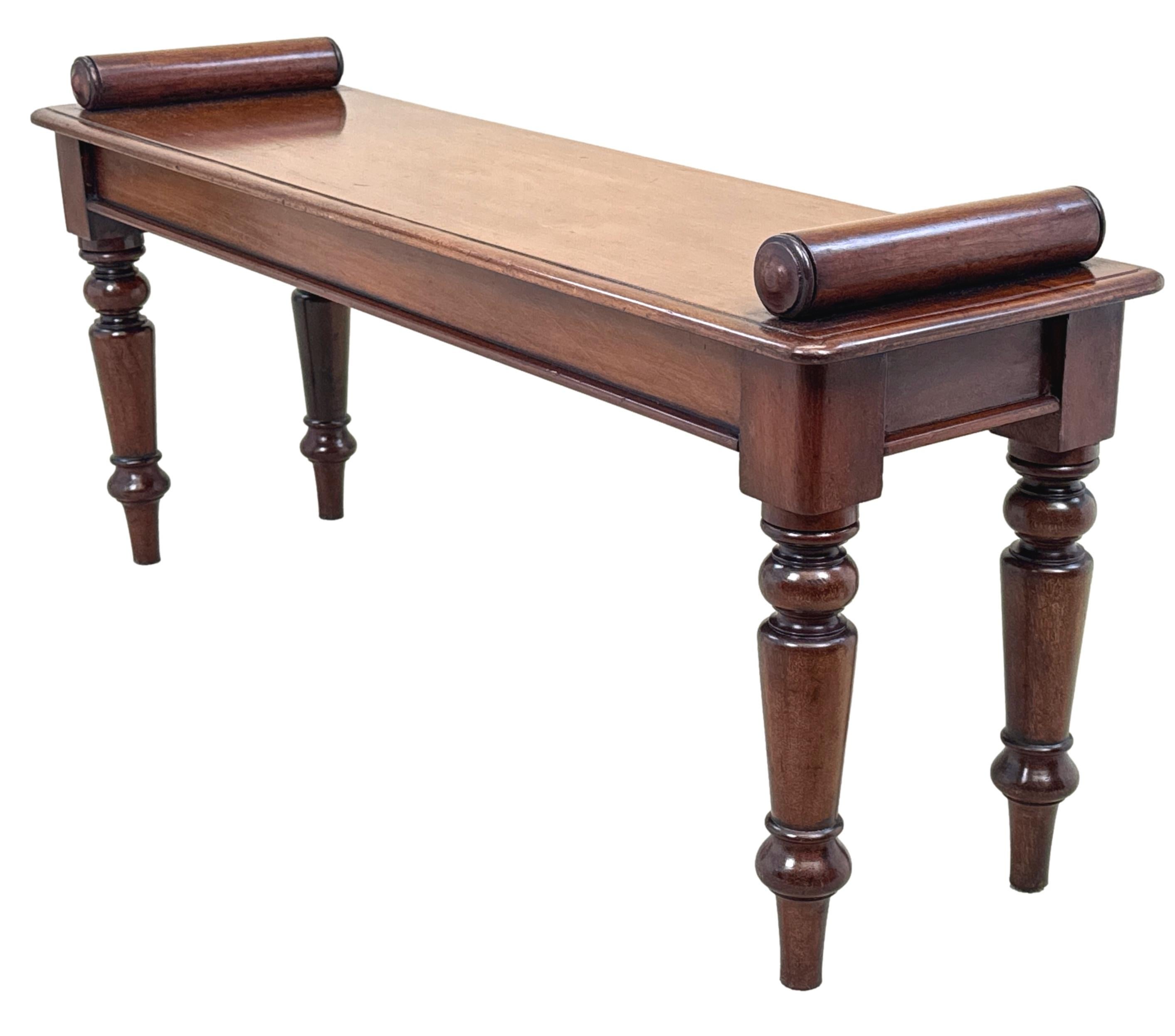 A Good Quality Mid 19th Century, Victorian Period, Mahogany Window Seat, Or Hall Bench, Having Well Figured Rectangular Top With Turned Rolls Applied To Each End, Raised Elegant Turned Tapering Legs.


Hall benches from the 19th century often follow