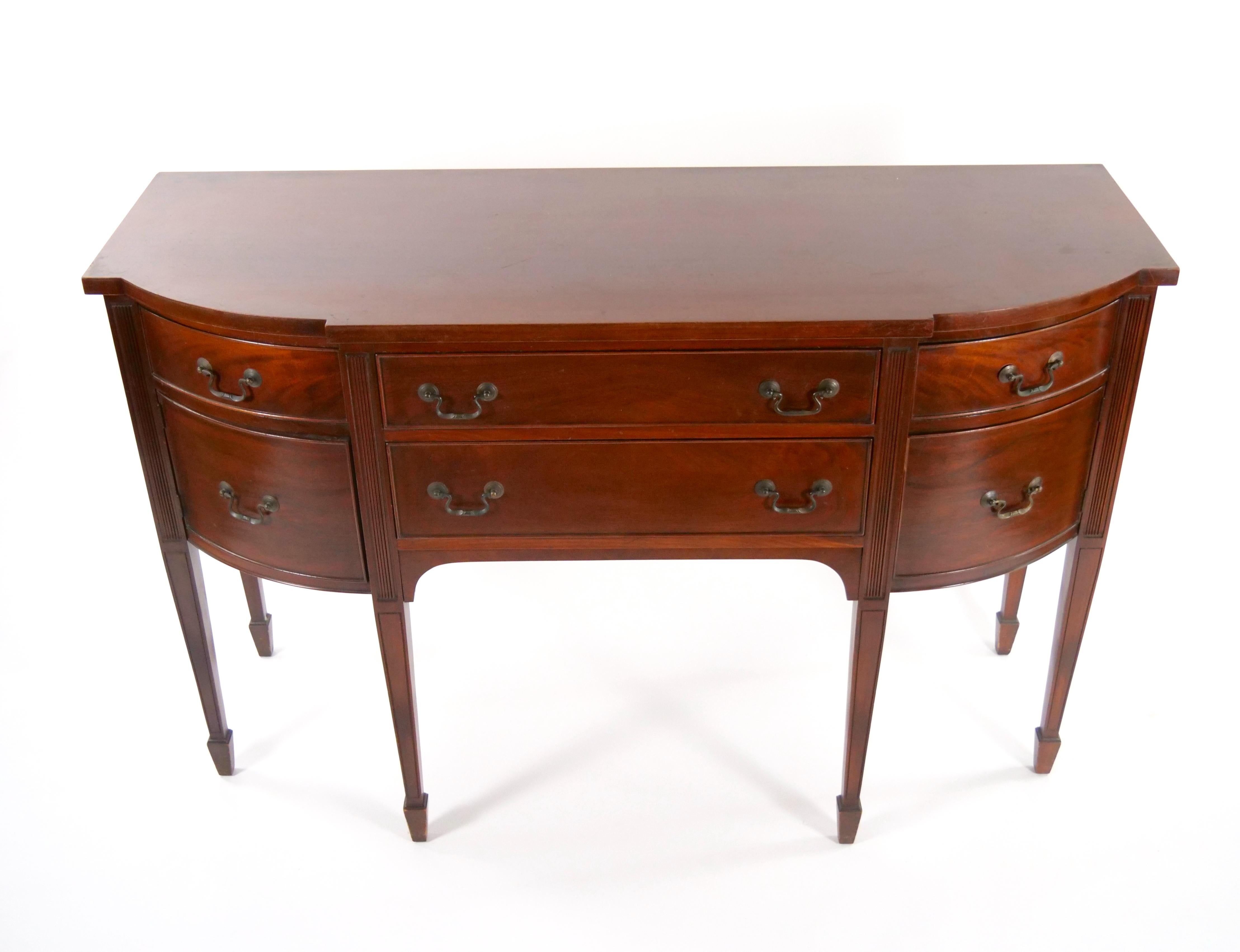 Immerse yourself in the rich history and enduring beauty of the Late 19th Century with our distinguished Mahogany Wood Bow-Front Buffet/Server. This antique masterpiece showcases a bow-front design, featuring two center drawers elegantly flanked by