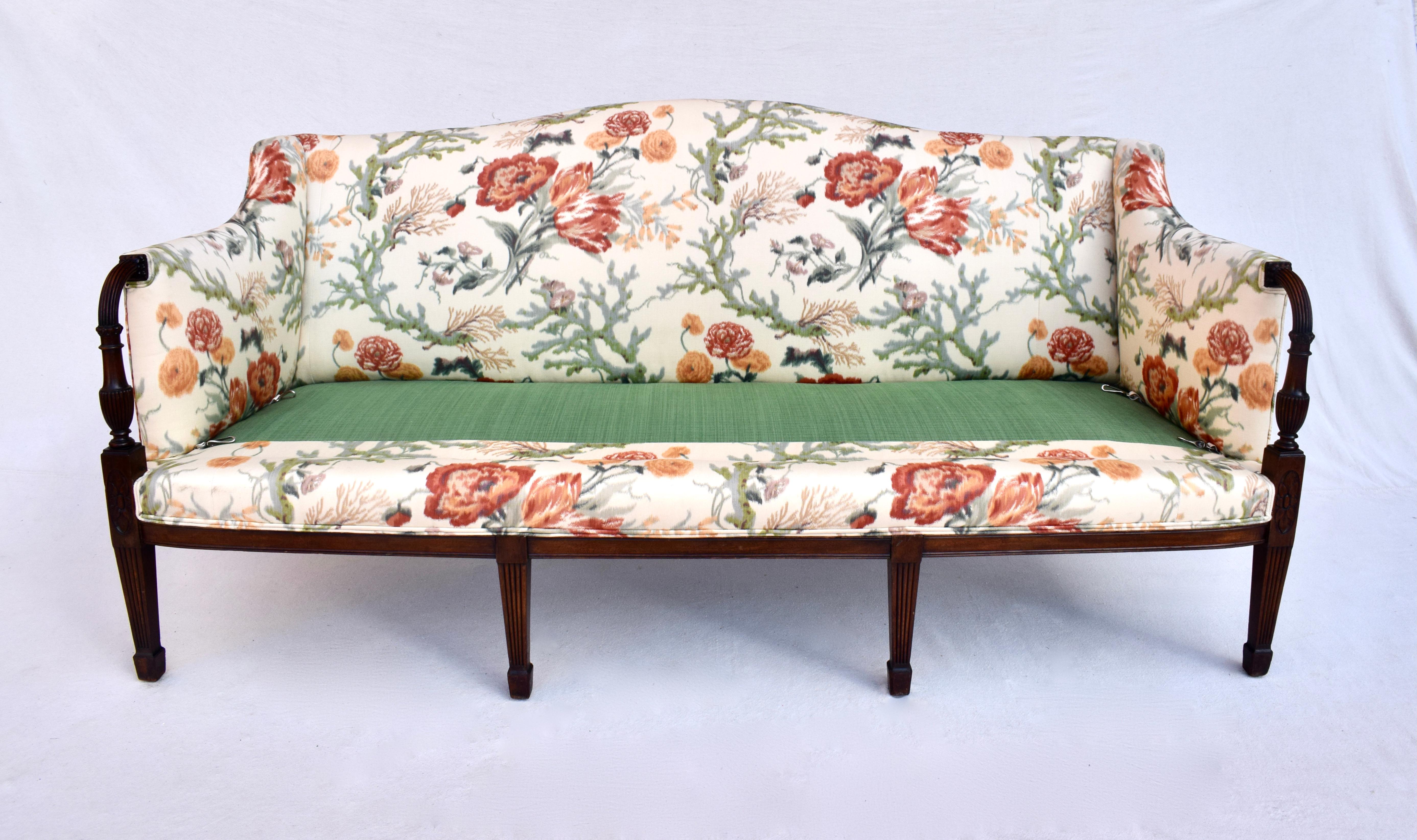 An exquisite 19th century solid mahogany wood framed Federal Sheraton style sofa with hand carvings throughout resting on eight legs. Reupholstered in Brunschwig & Fils Ikat floral featuring one single exceptionally plush goose down cushion in