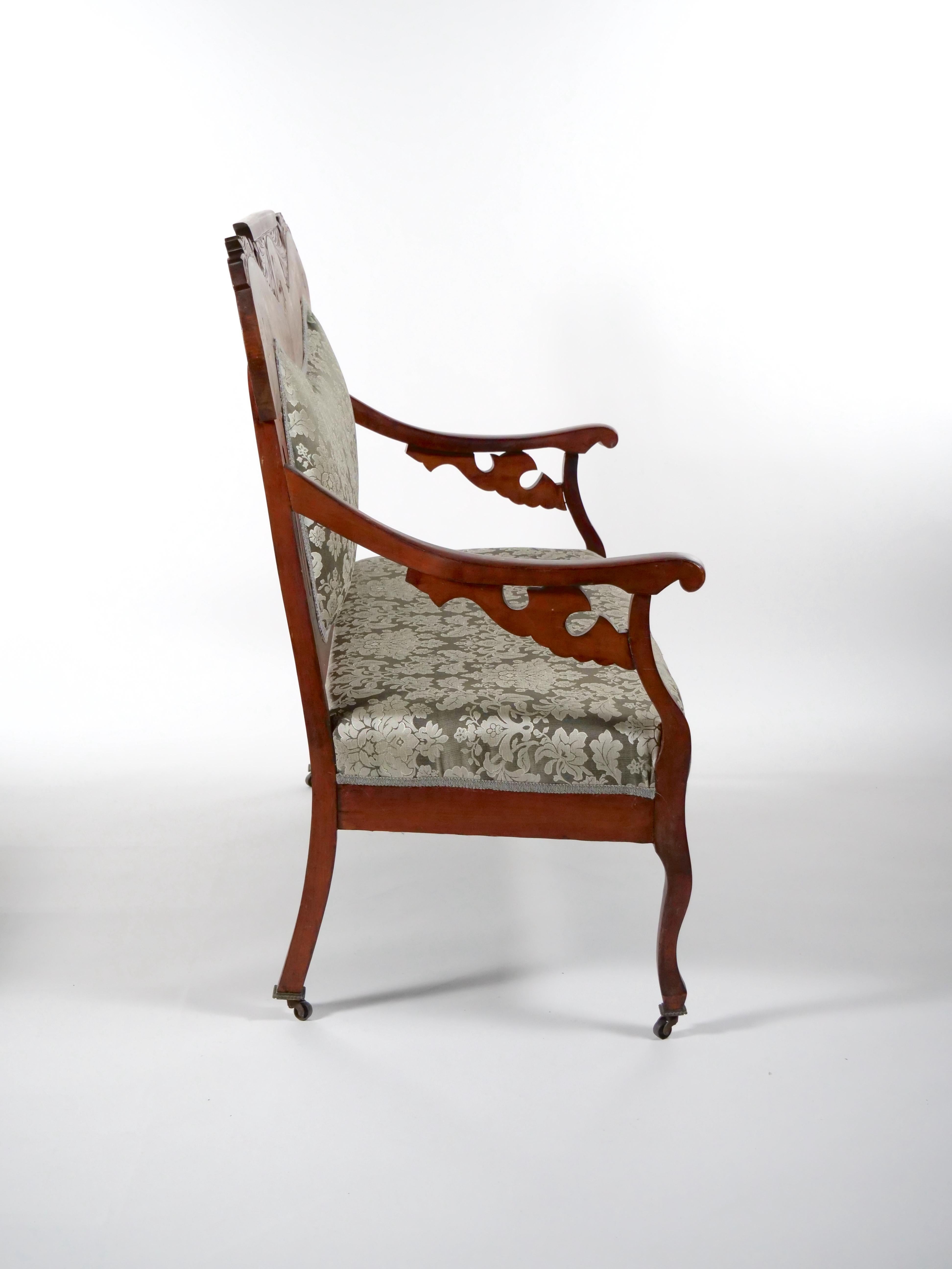 Fine quality and beautifully hand carved with inlaid marquetry mahogany wood frame settee. The settee features a wood frame inlaid top foliate decoration , resting on four square hand carved tapered feet terminate with metal cup hardware wheeled