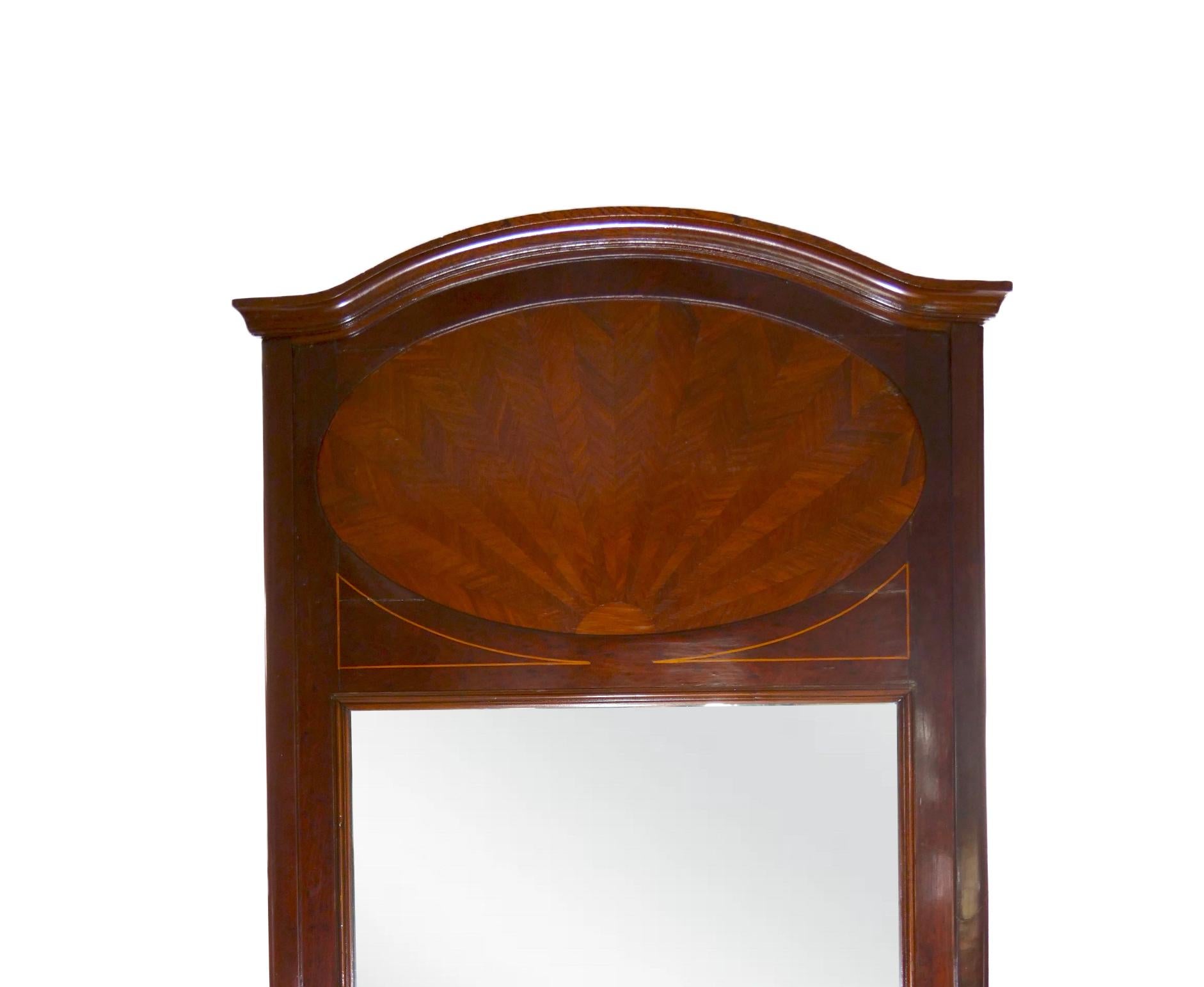 Beautiful craftsmanship of the mid-19th century beveled mahogany wood frame hanging trumeau wall mirror with inlaid top design details. The mirror is in great condition with appropriate wear consistent with age / use. It measures 72 inches high X 40