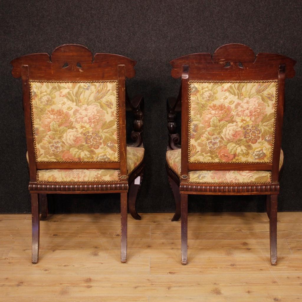 Pair of Italian armchairs from the second half of the 19th century. Richly carved mahogany wood furniture of exceptional quality and fabulous line. Comfortable armchairs upholstered in floral fabric with some small signs of wear. Padding in good