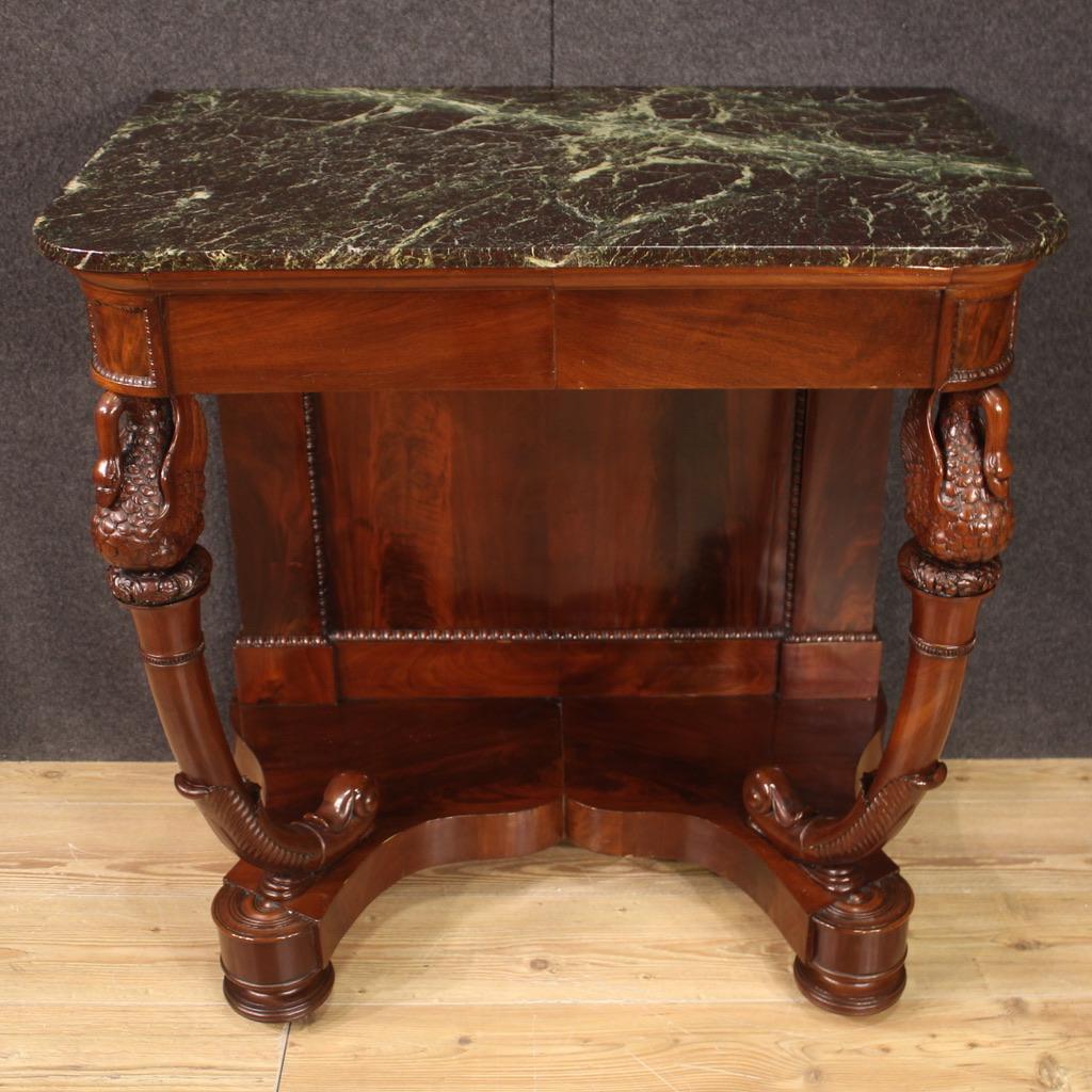 Antique Italian console from the first half of the 19th century. Charles X period furniture carved in mahogany wood with saber front legs carved with motifs of excellent quality swans. Console of excellent size and proportion with marble top of good