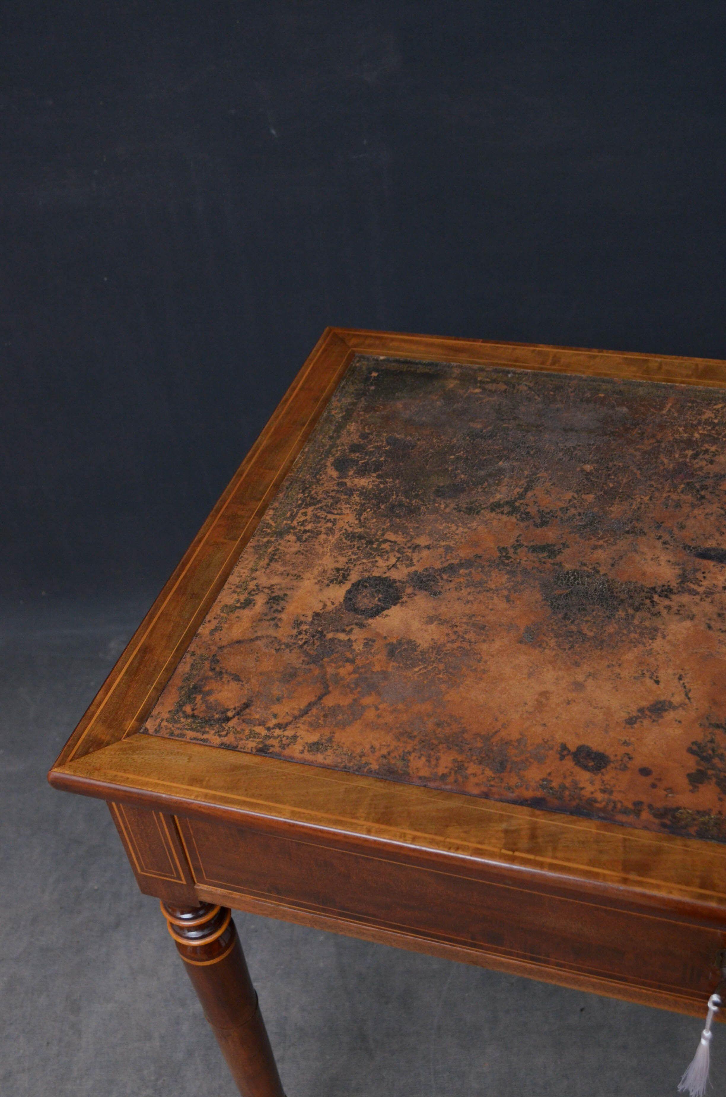 Sn5242 Attractive mahogany table, having original leather writing surface showing extensive usage and good antique character above frieze drawer fitted with original working lock and a key, raised on turned and ringed legs terminating in ball feet.