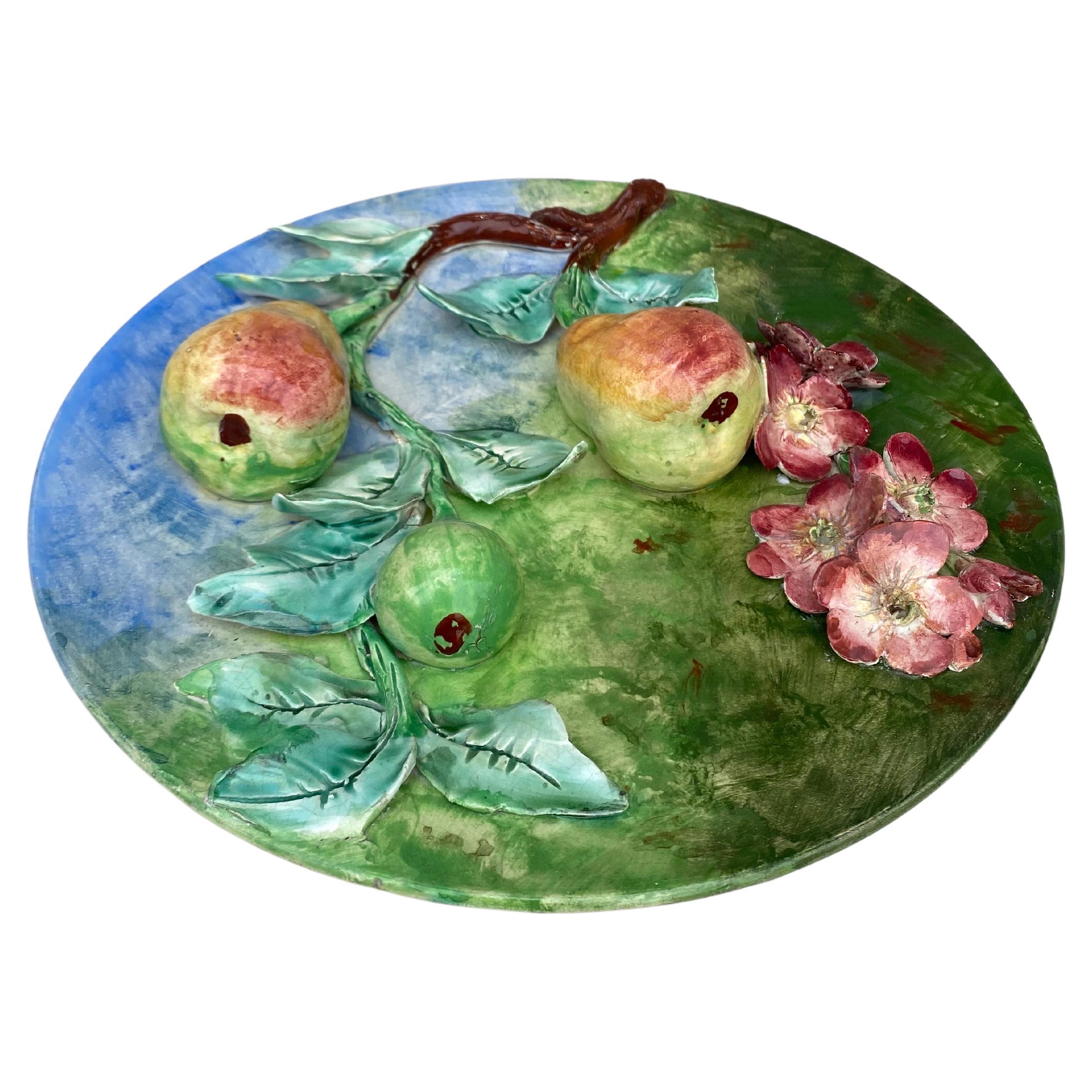 Colorful 19th century French Majolica pear wall platter signed Longchamp terre de fer. The fruits are in high relief with the leaves and branches.
The manufacture of Longchamp produced this fruits platters with various fruits in four different