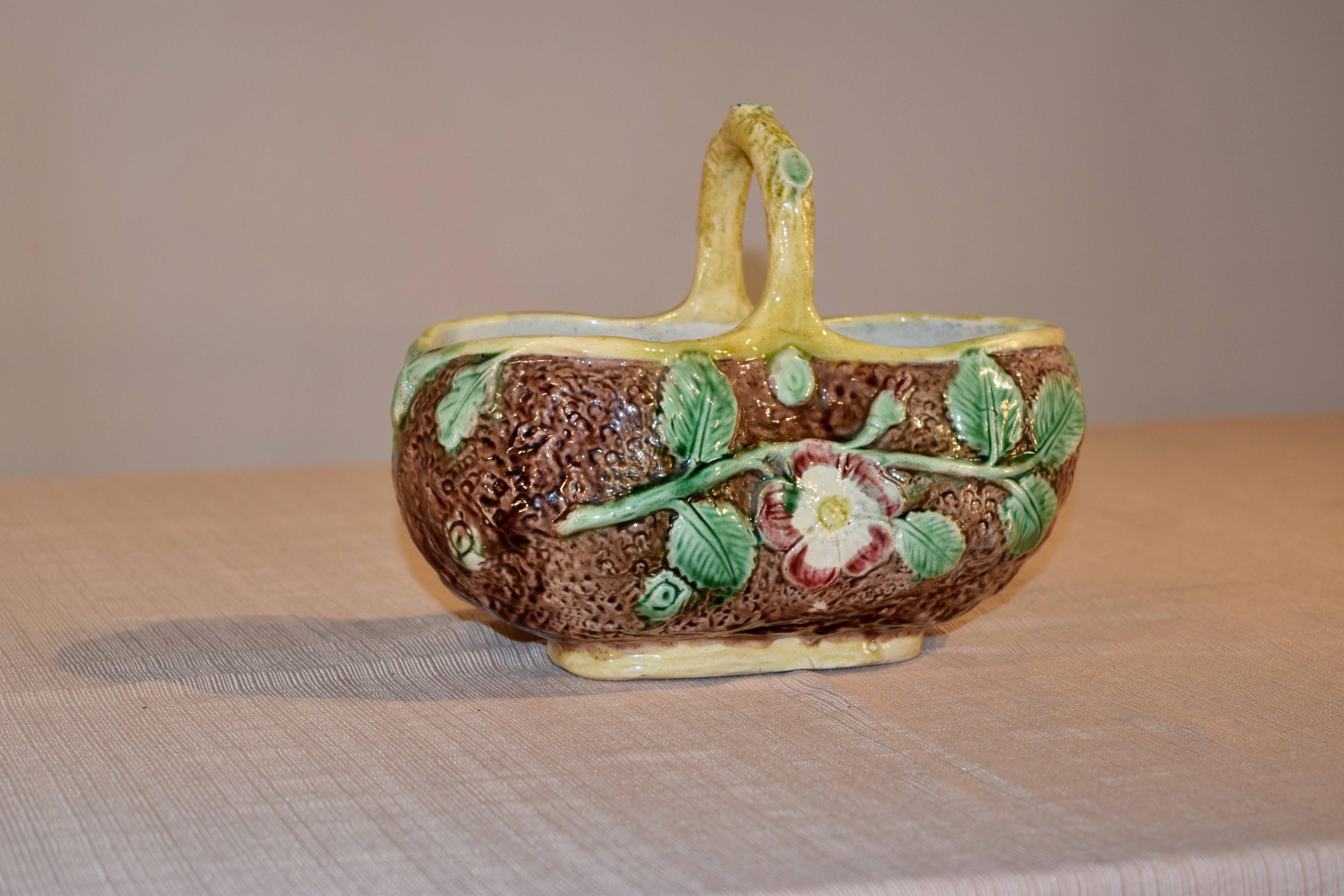 19th century Majolica basket from England in the form of a log with flowers and vines.