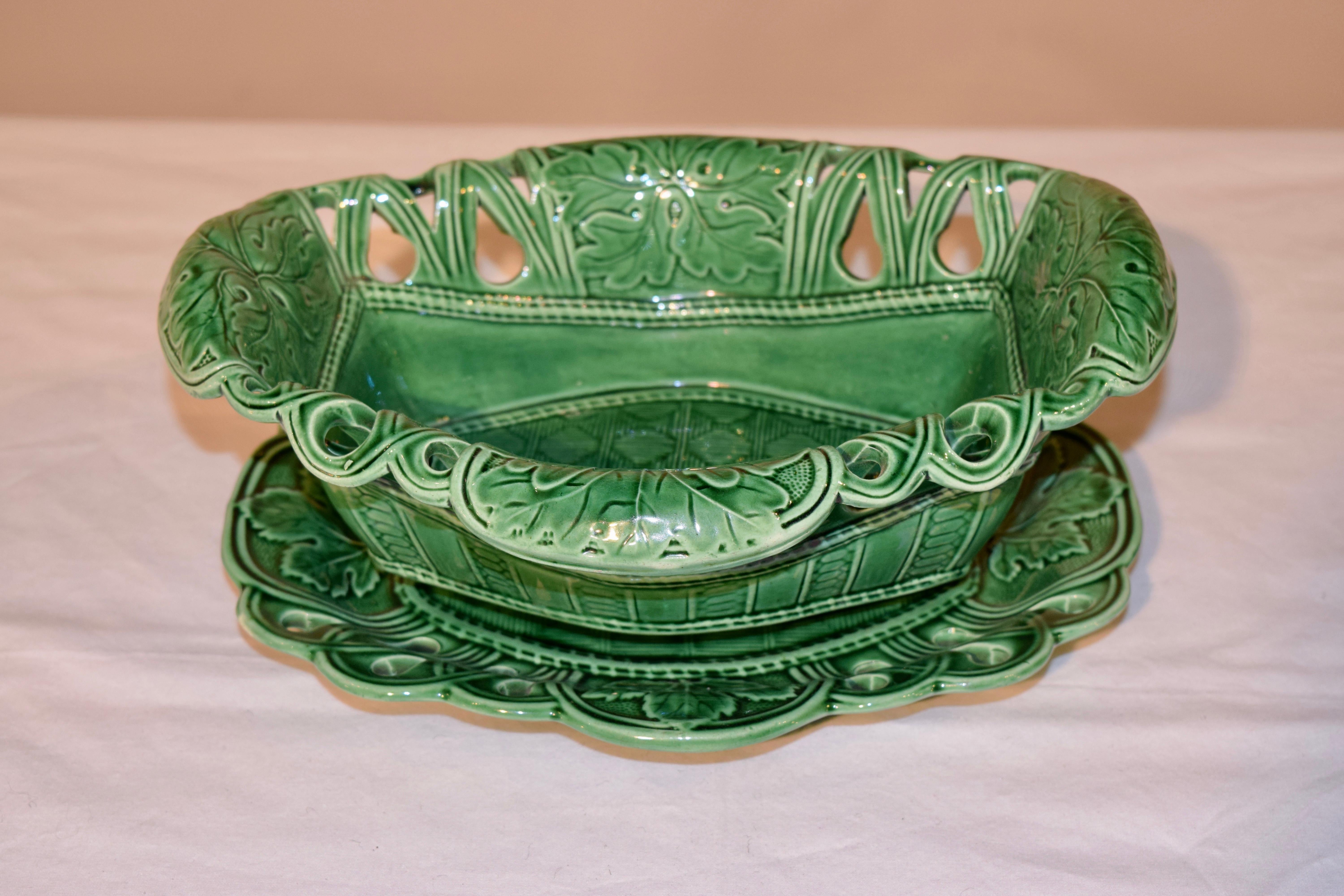 Rare 19th century Majolica reticulated bowl and under tray with a gorgeous molding and leaf decoration. Wonderfully detailed and glazed in vibrant green. Measurements of the under tray are 10.38 x 8.38 x 1.25. Very unusual set for any collection.
 