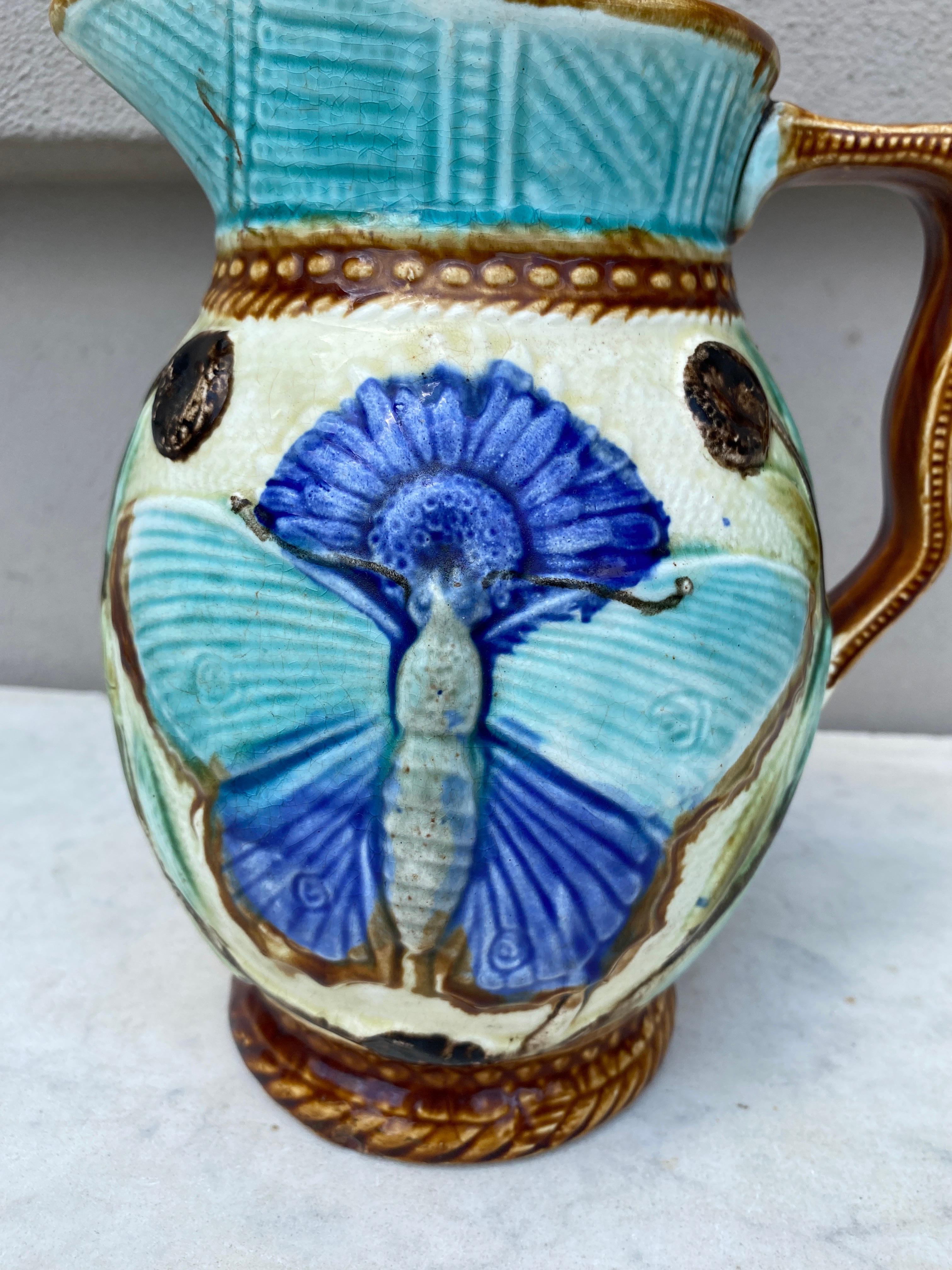 Large 19th century Belgium Majolica pitcher Wasmuel with a butterfly.