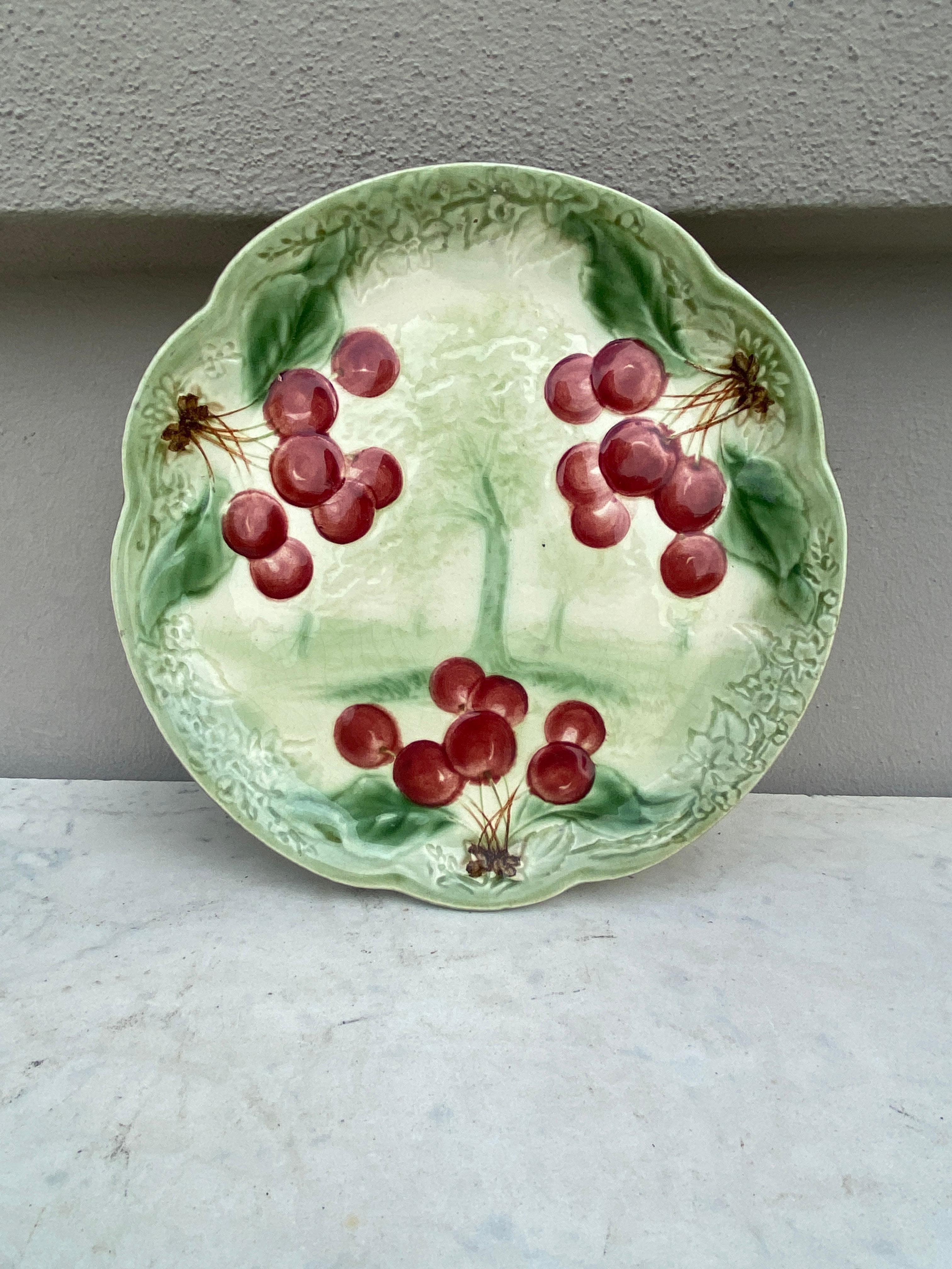 19th century Majolica Cherries Plate signed Choisy Le Roi.
Made for Higgins & Setter New York.
The Higgins & Seiter Company of New York City began selling decorations for the table, including rich-cut glass in 1887. By 1891 the firm was