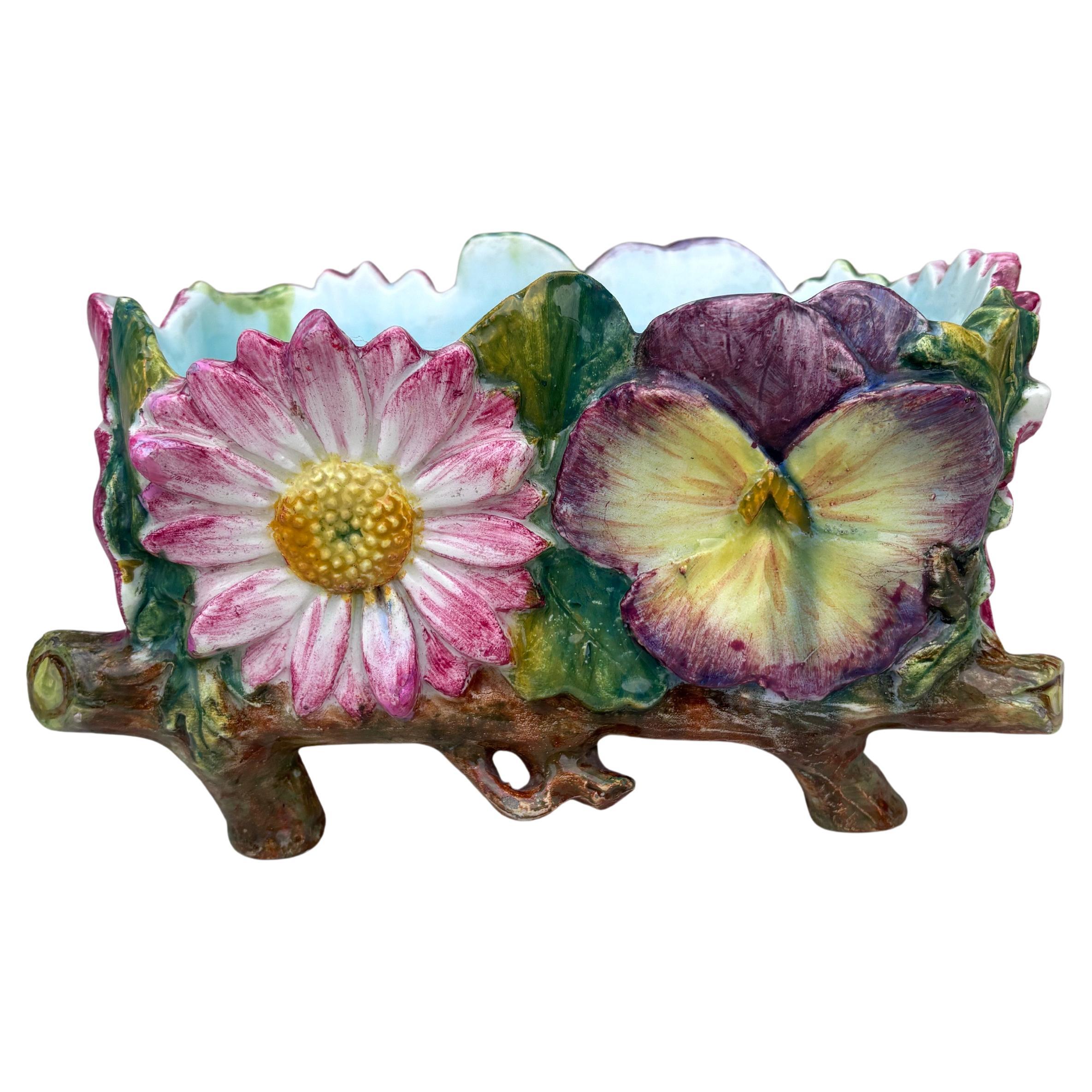 Unusual Majolica large jardiniere with flowers daisies, pansies, wild roses surrounded by branches signed Delphin Massier.
9.5 inches W.
5 inches H.