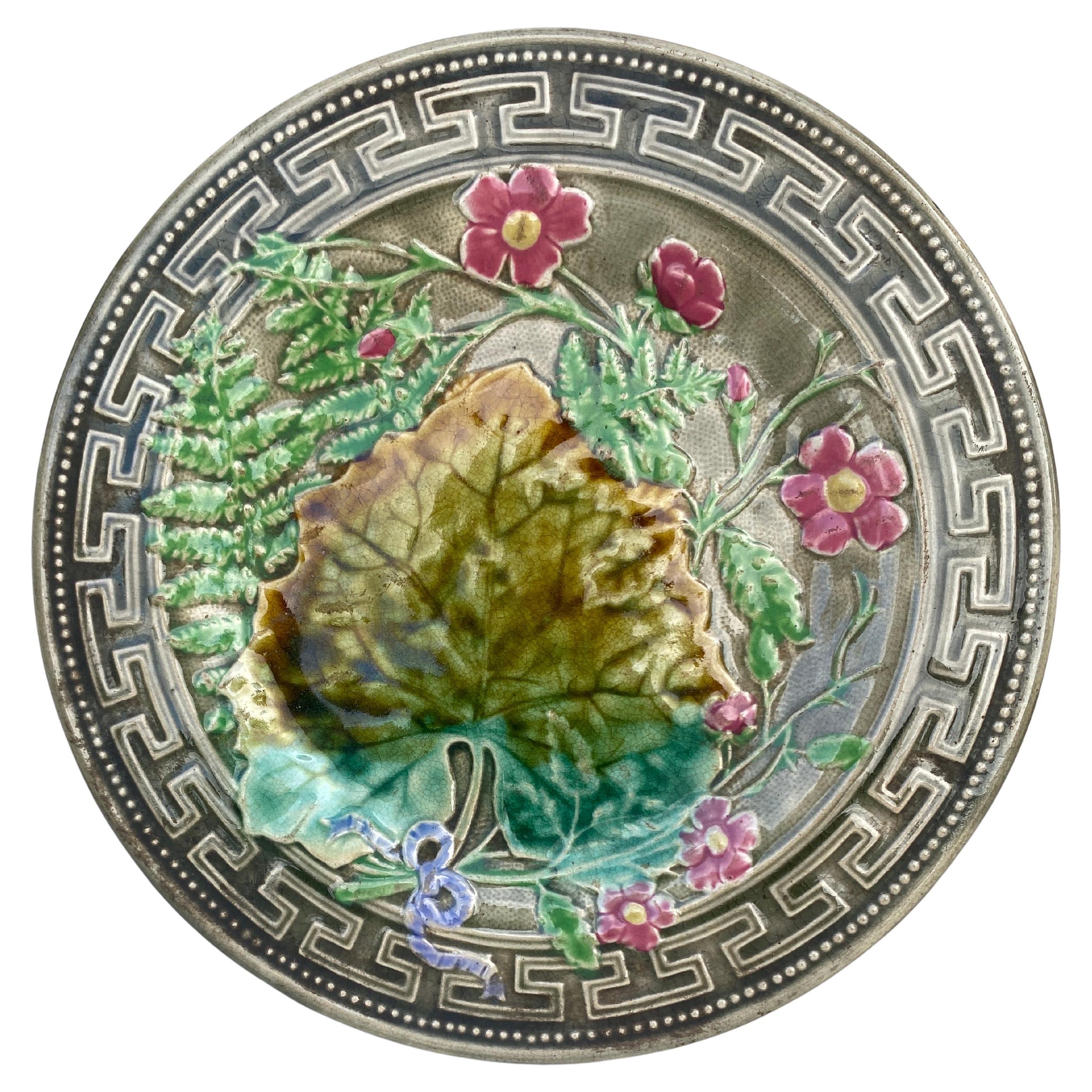 Majolica plate signed Choisy le roi, circa 1890.
Decorated with leaves, ferns, pink flowers and Greek border.