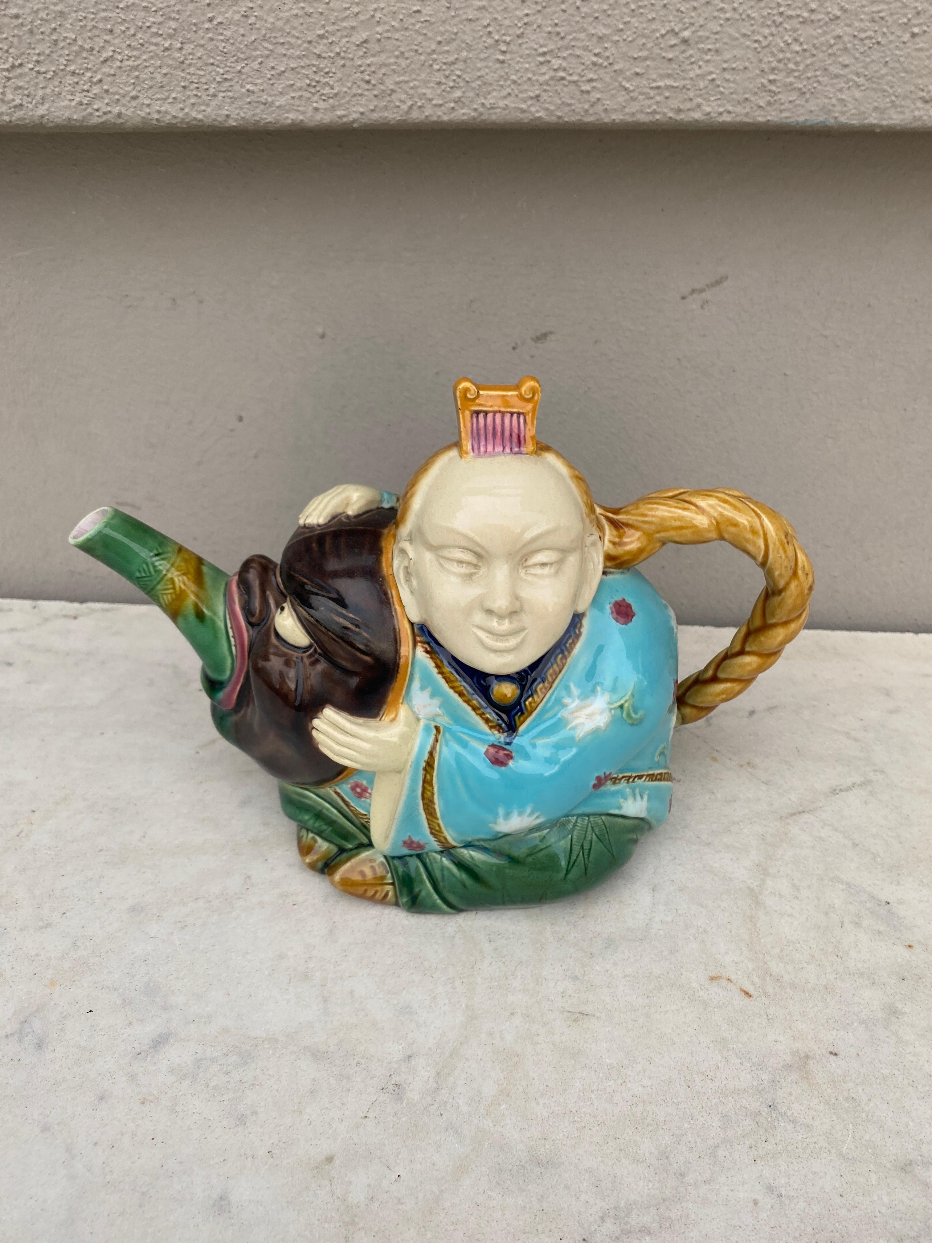 Majolica figural teapot signed Minton.
Modeled as a Chinaman , the tail formed as the Chinaman’s pigtail, his head forming the cover with his hair comb forming the finial.
Reference 