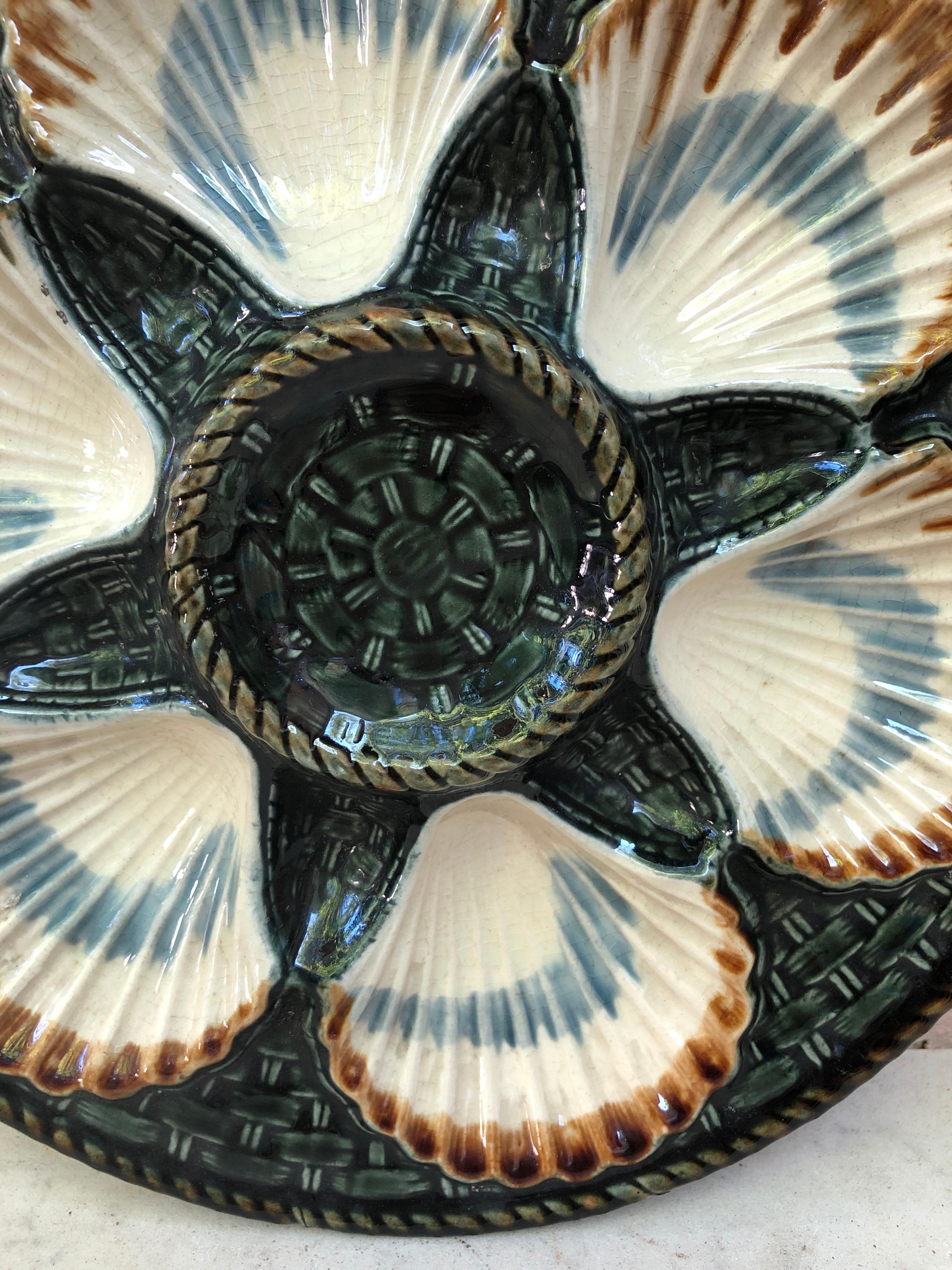 Green Majolica oyster plate, six white wells on a green basket weave, circa 1890 signed longchamp.