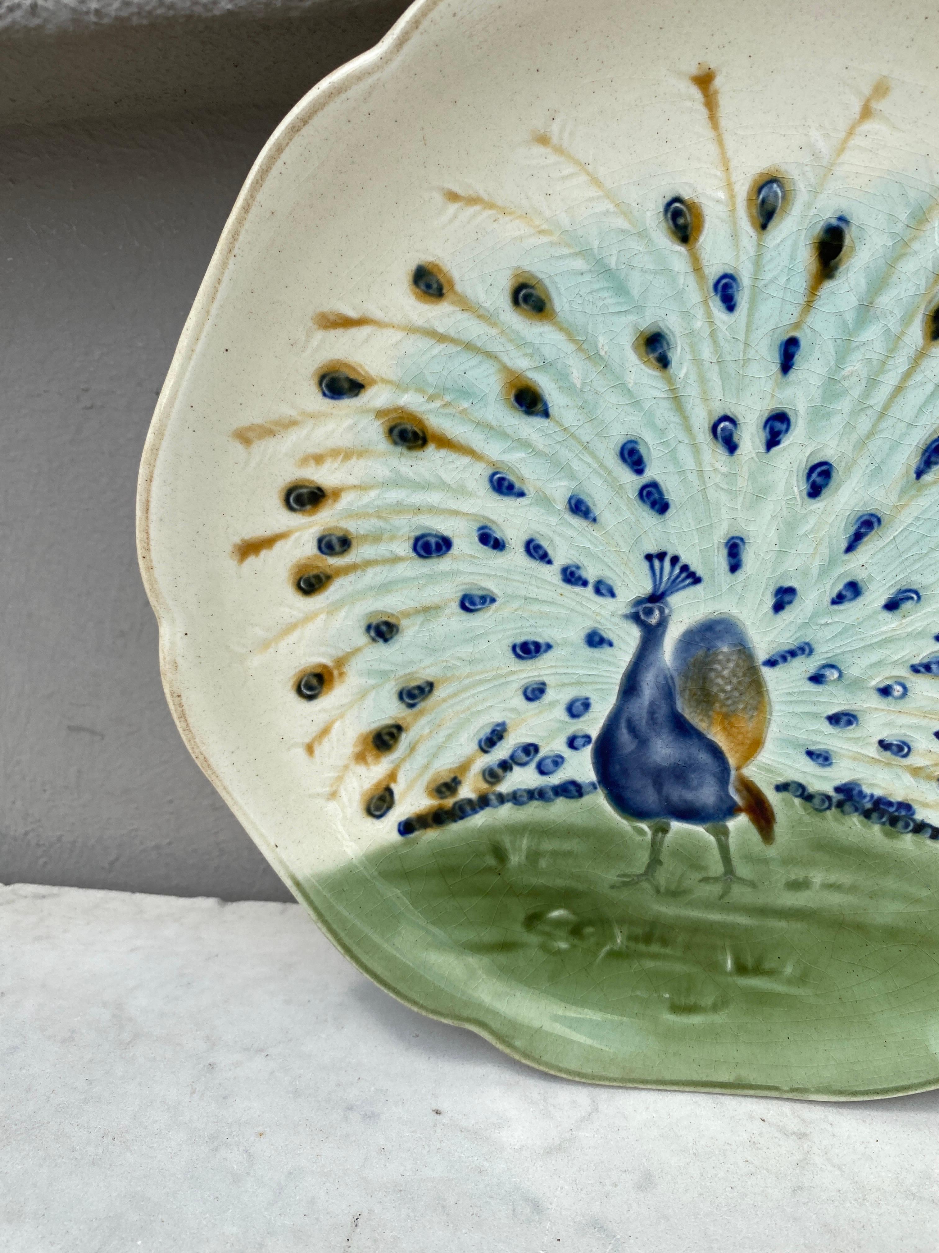 Majolica plate with a peacock signed Hippolyte Boulenger Choisy le Roi, circa 1890.
The manufacture of Choisy le Roi was one of the most important manufacture at the end of 19th century, they produced very high quality ceramics of all kinds as