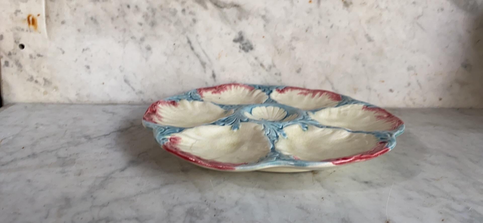 Rare 19th century Majolica oyster plate with pastels colors, shells and seaweeds signed Gien.
