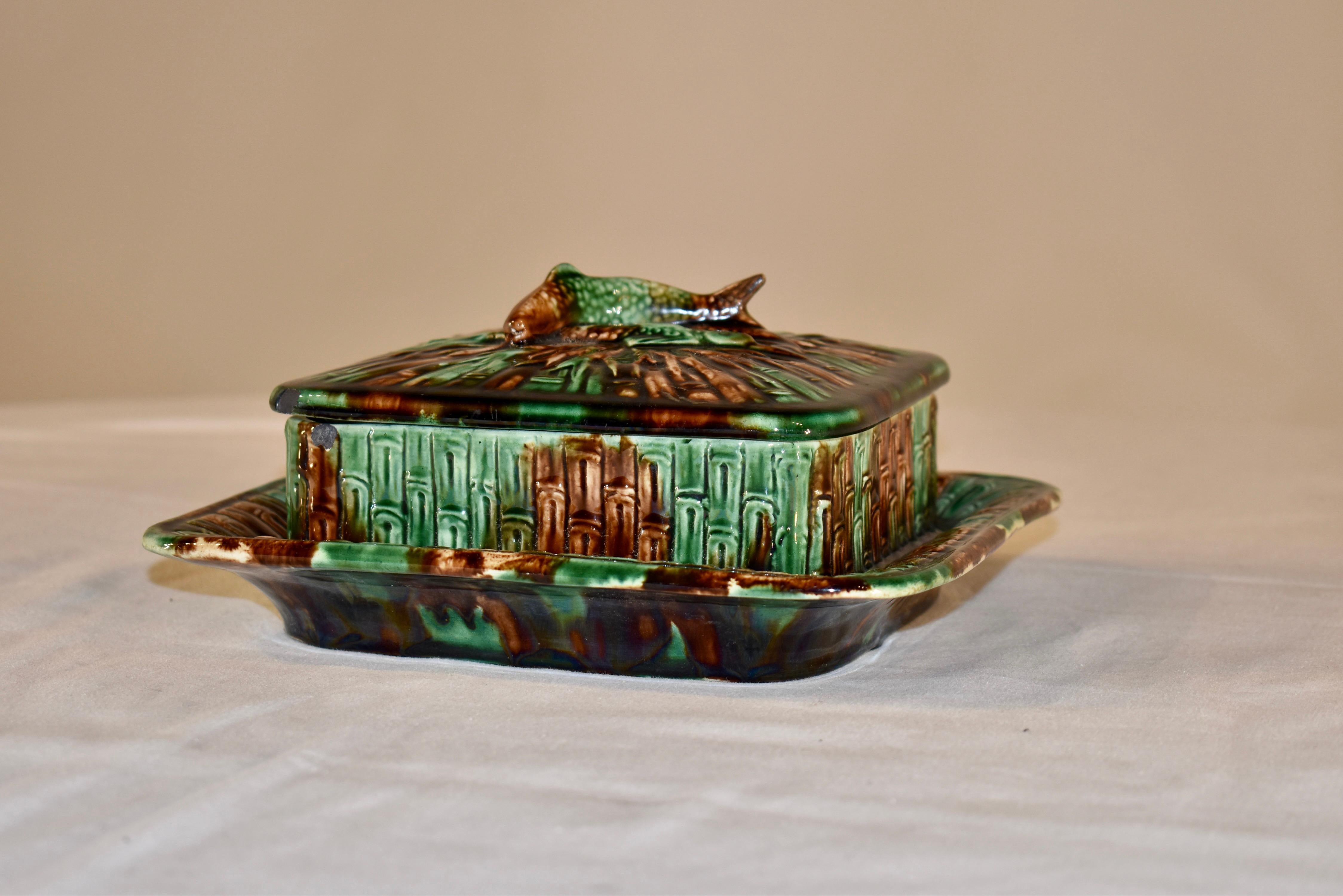 19th century English majolica sardine box. The box is in the form of a fishing basket, or creel, with a pair of fish laid across the lid for decoration. The colors are fantastic mottled in green and brown. Gorgeous piece with tortoise pattern