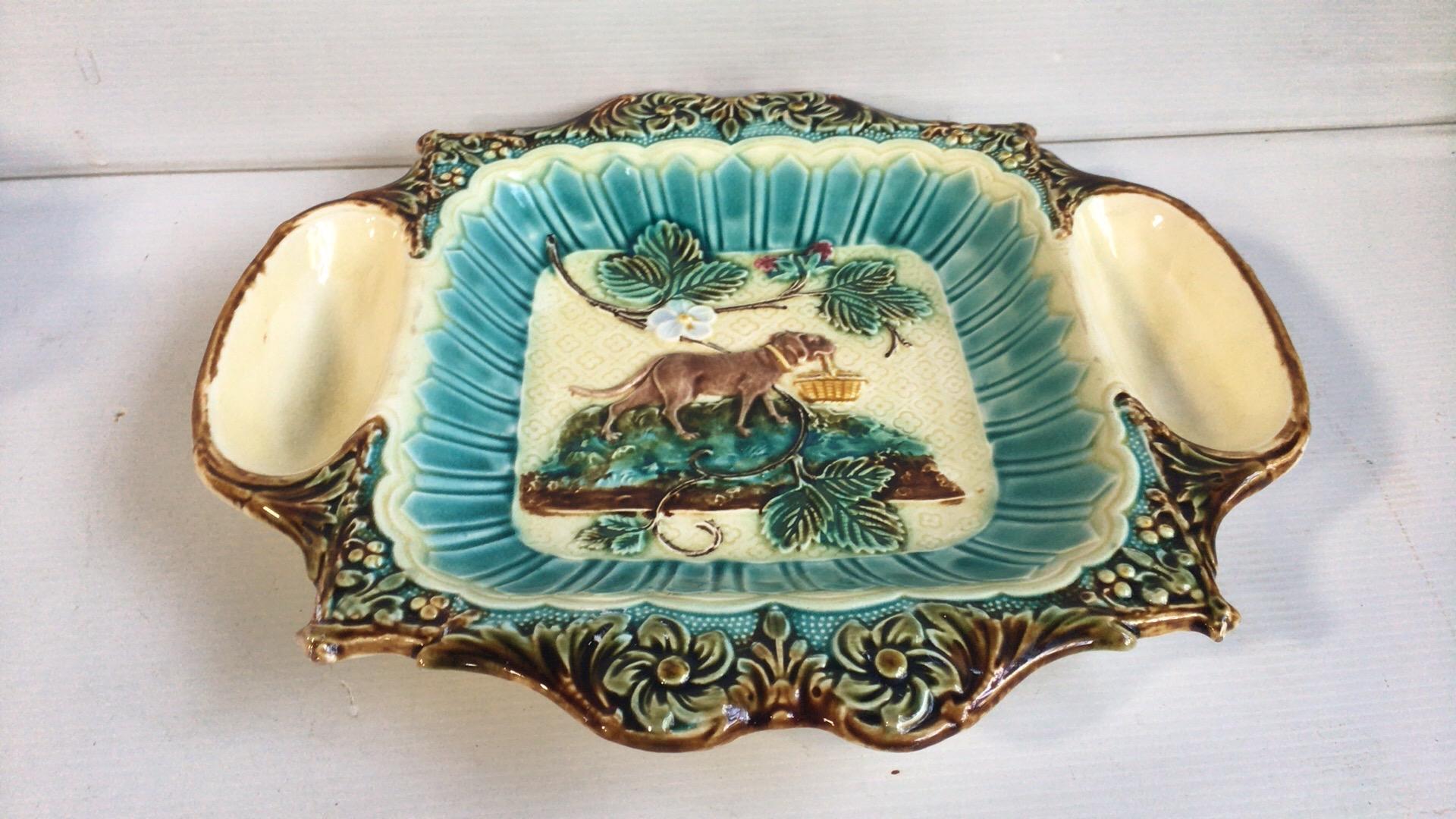 Unusual French Majolica strawberry server with cream and sugar spaces, circa 1890, attributed to Onnaing.
Sophistiqued leaves border, the center is decorated with strawberries and a dog holding a basket.
 
    
