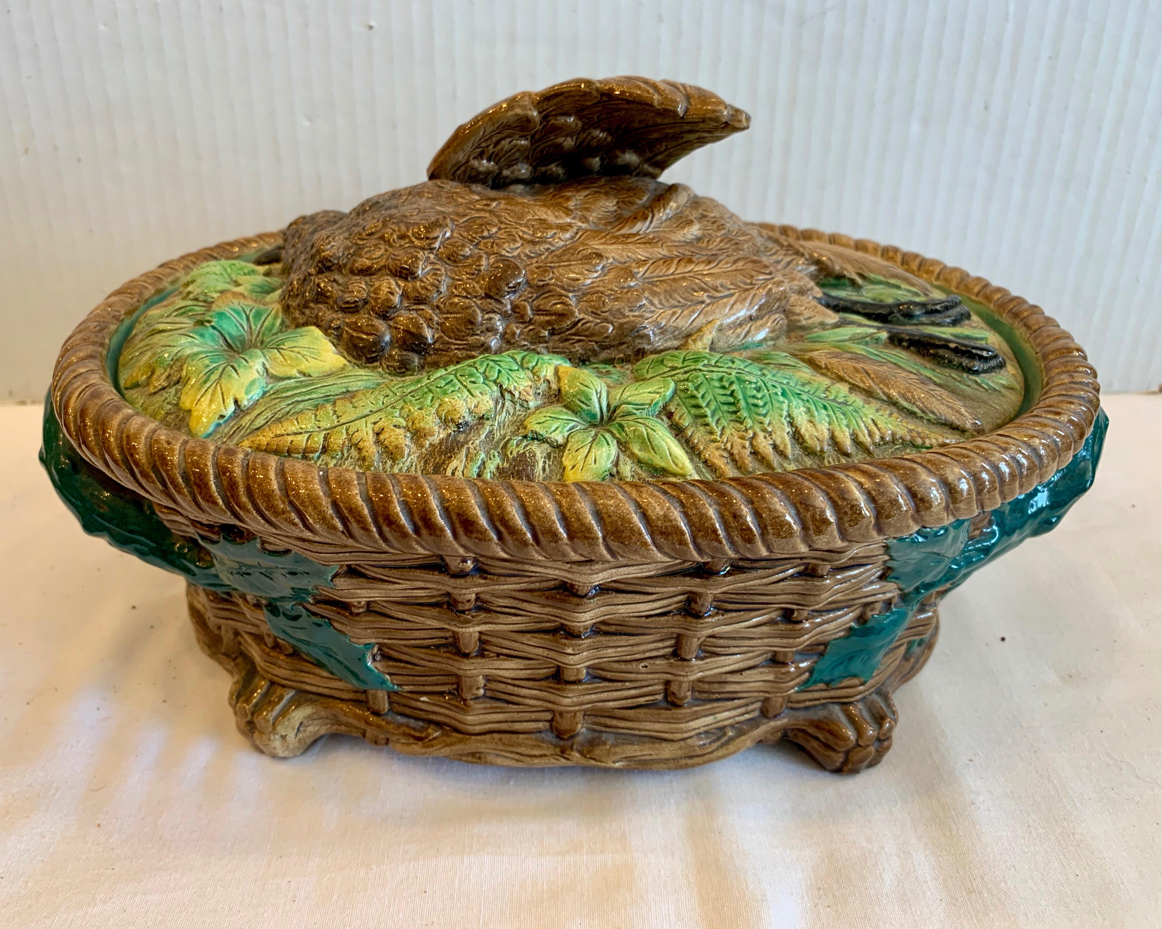 Fashioned with a figure of a bird on its lid. The piece is designed with handles at its sides ,as well. Generously scaled with exceptional detail - highly stylized
with good colors