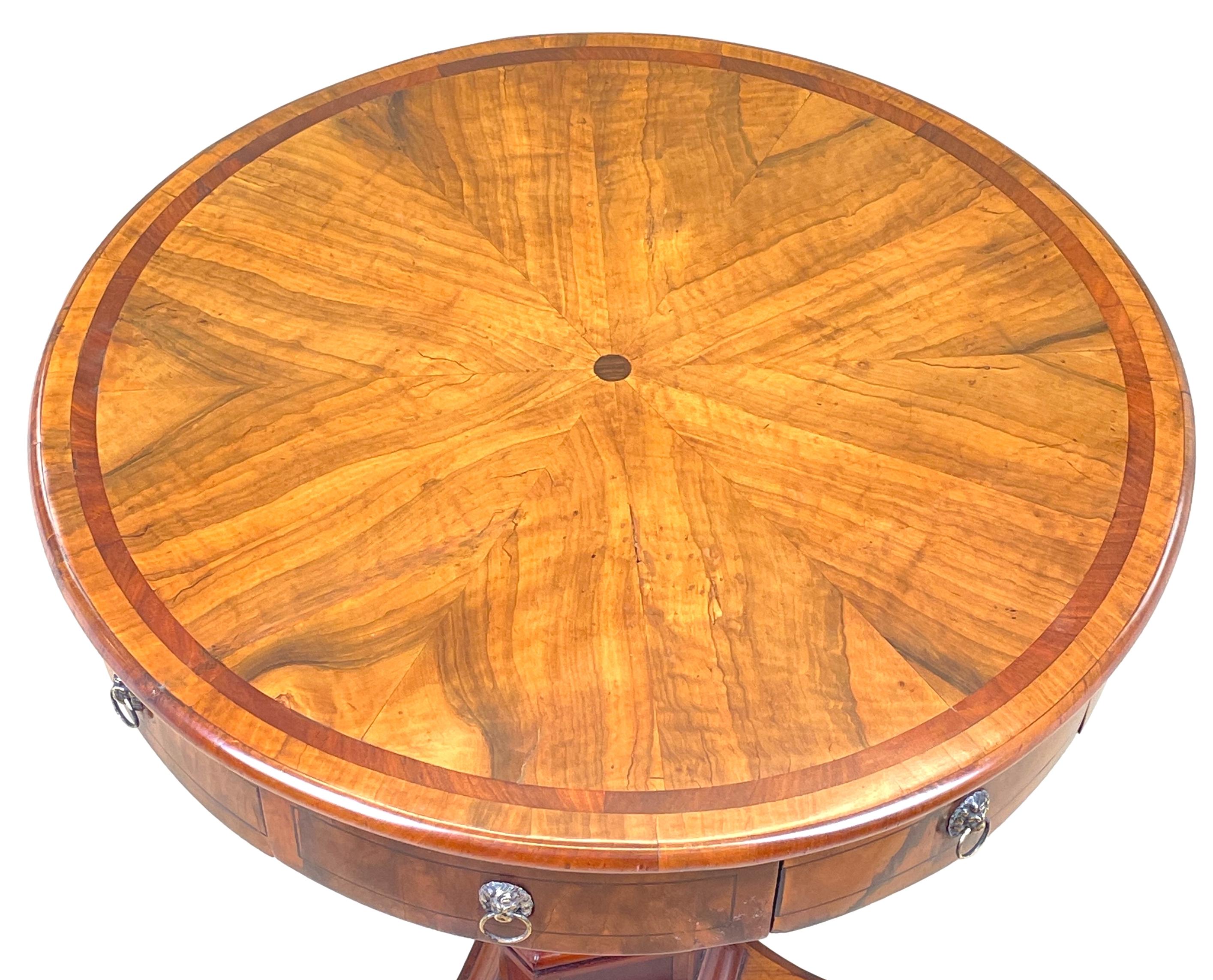 A very good quality 19th century, late regency period, olive wood maltese type drum table, having extremely well figured circular top, with crossbanded decoration, over four drawers and four false drawers, raised on triangulated column and triform