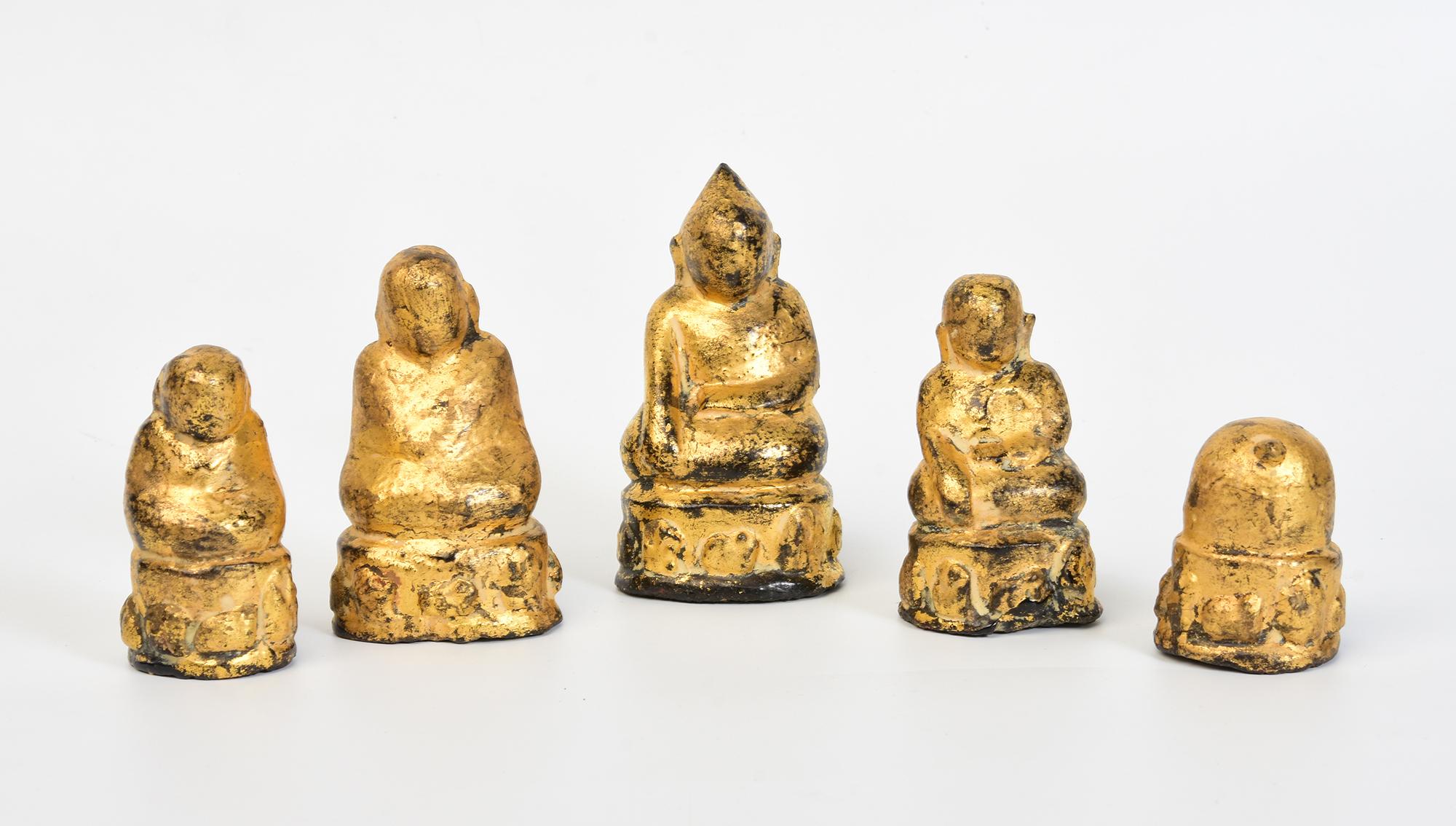 Ein Satz antiker birmanischer Amulette aus lackiertem Holz und mit Blattgold vergoldet. 
Es wird angenommen, dass diese Art von Statuette aufgrund der Paste aus heiliger Asche und Heilkräutern, die in das Loch im Sockel der Statuette eingeführt und