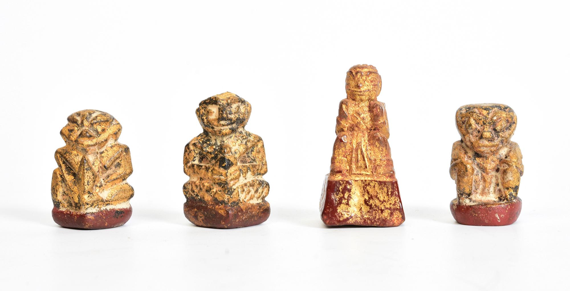 A set of antique Burmese amulets in lacquered wood and gilded with gold leaf. 
It is believed that this type of statuette had special powers due to the paste made from sacred ashes and medicinal herbs, which was inserted into the hole in the base of