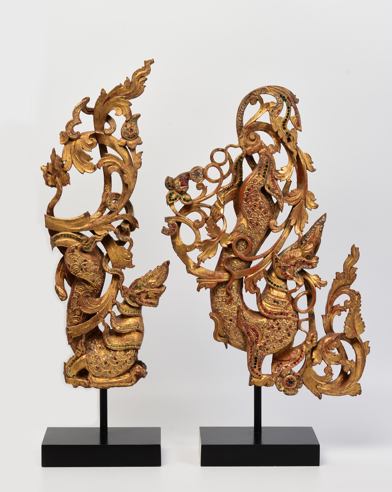 A set of two pieces of antique Burmese wood carving Nagas with gilded gold and glass.

Age: Burma, Mandalay Period, 19th Century
Size excluding stand: Height 51.5 - 52.7 C.M. / Width 20 - 34.2 C.M. / Thickness 4 - 4.6 C.M.
Height including stand: 61