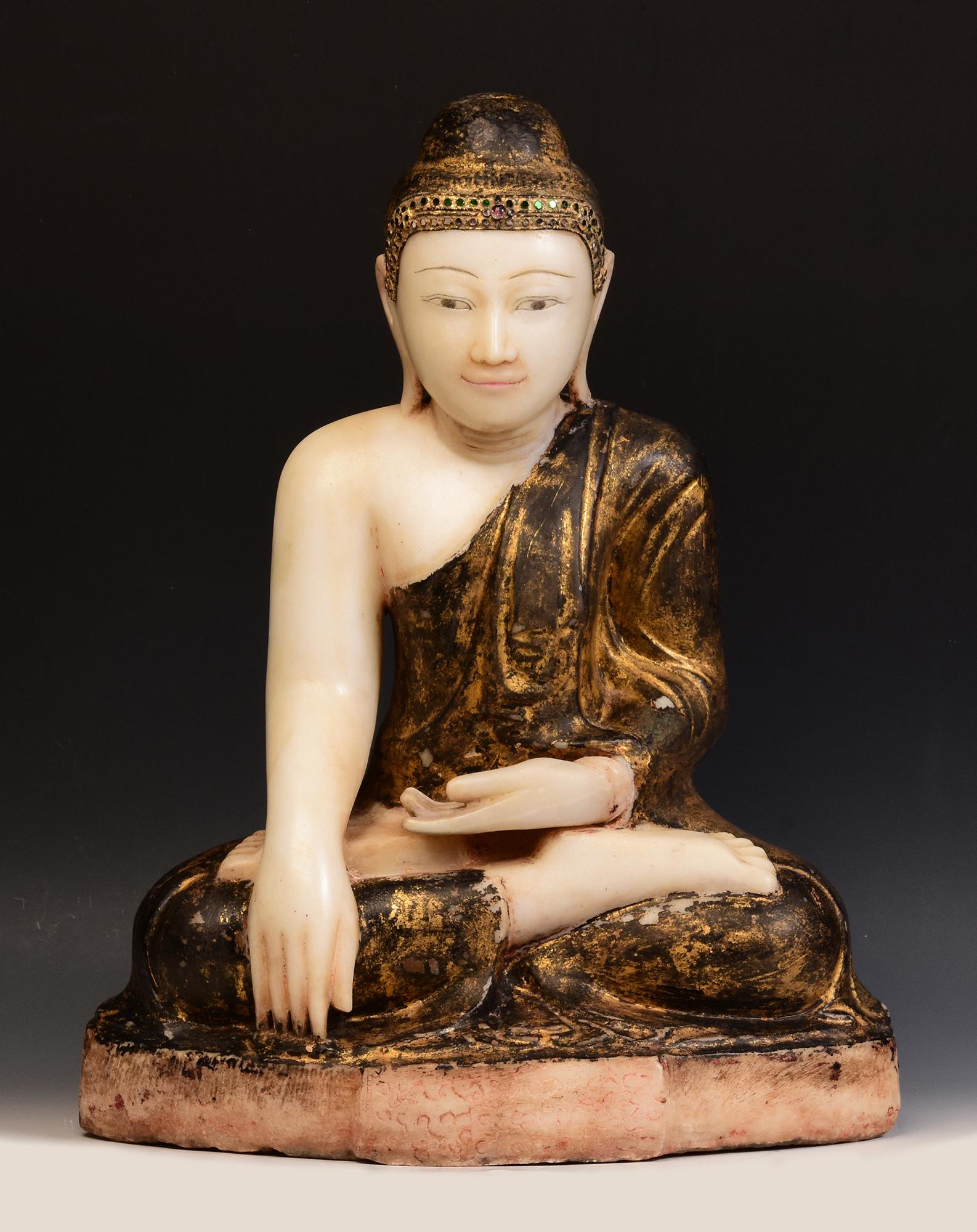 Antique Burmese alabaster Buddha sitting in Mara Vijaya (calling the earth to witness) posture on a base, with original lacquer and inlay of colorful glass pieces on the headband.

Age: Burma, Mandalay Period, 19th Century
Size: Height 58 C.M. /