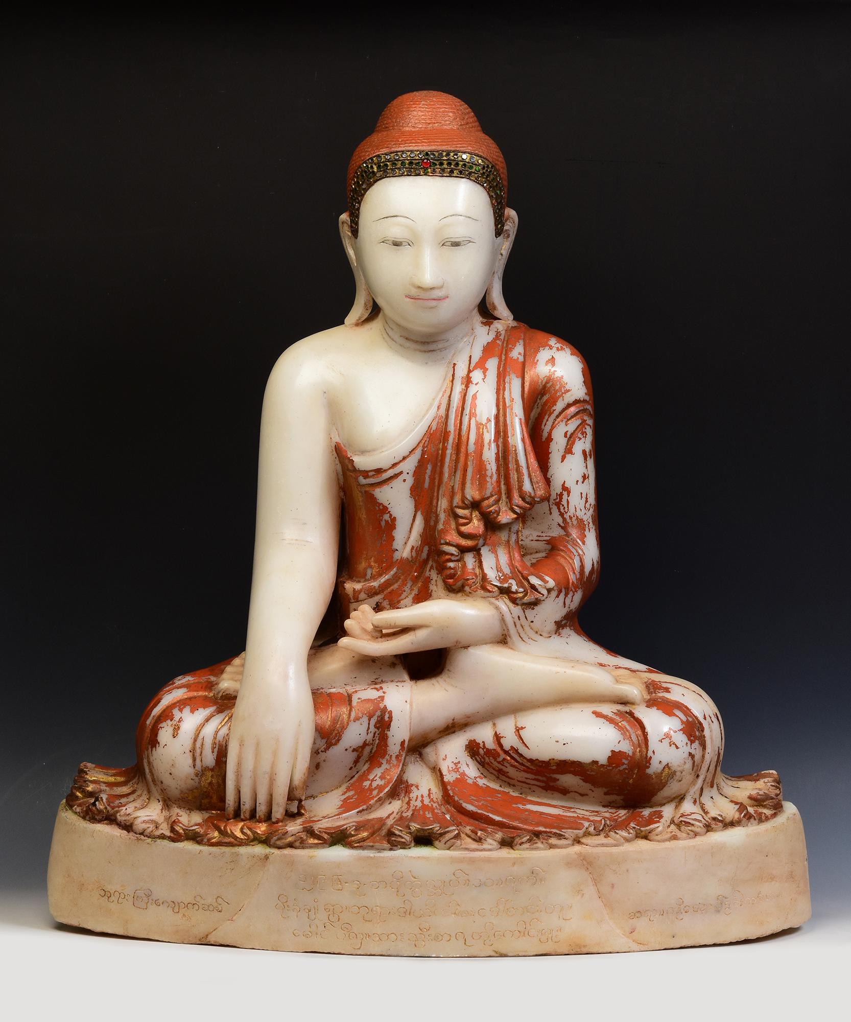 Antique Burmese alabaster Buddha sitting in Mara Vijaya (calling the earth to witness) posture on a base, with original lacquer and inlay of colorful glass pieces on the headband.

Age: Burma, Mandalay Period, 19th Century
Size: Height 75 C.M. /