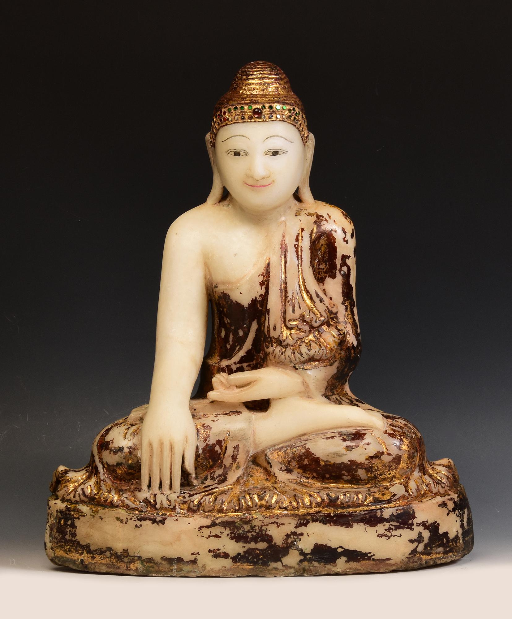 Antique Burmese alabaster Buddha sitting in Mara Vijaya (calling the earth to witness) posture on a base, with inlay of colorful glass pieces on the headband.

Age: Burma, Mandalay Period, 19th Century
Size: Height 44.5 C.M. / Width 37 C.M. / Depth