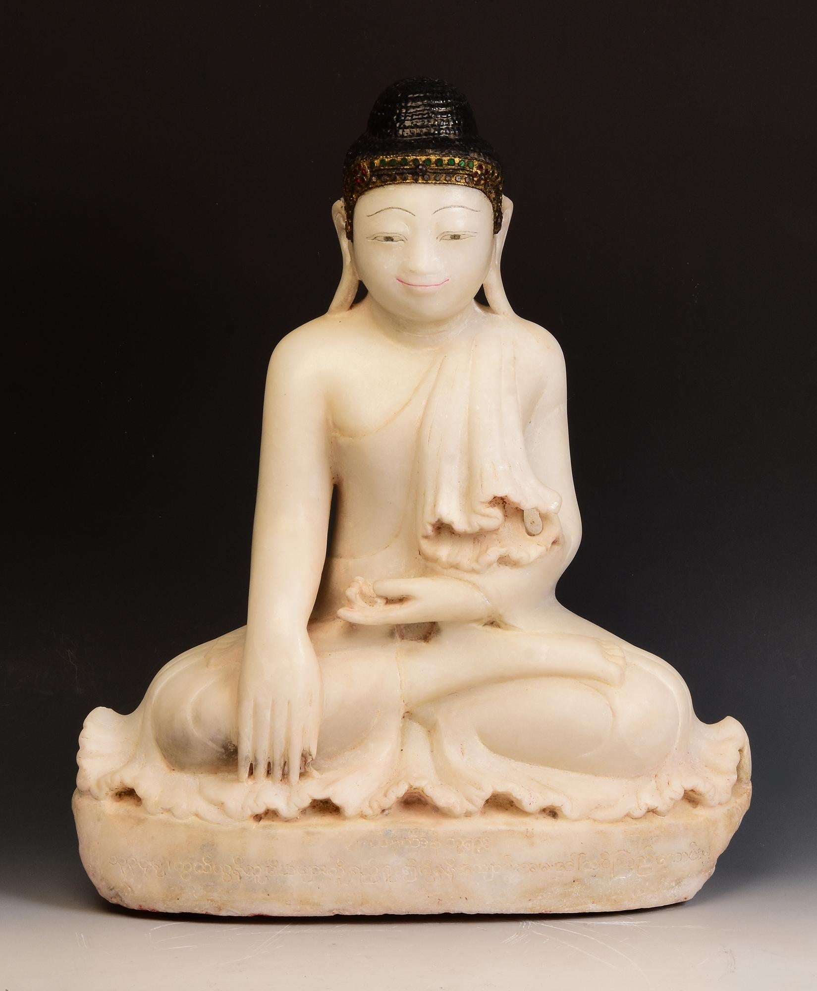 Antique Burmese alabaster Buddha sitting in Mara Vijaya (calling the earth to witness) posture on a base, with inlay of colorful glass pieces on the headband.

Age: Burma, Mandalay Period, 19th Century
Size: Height 53 C.M. / Width 44.5 C.M. / Depth