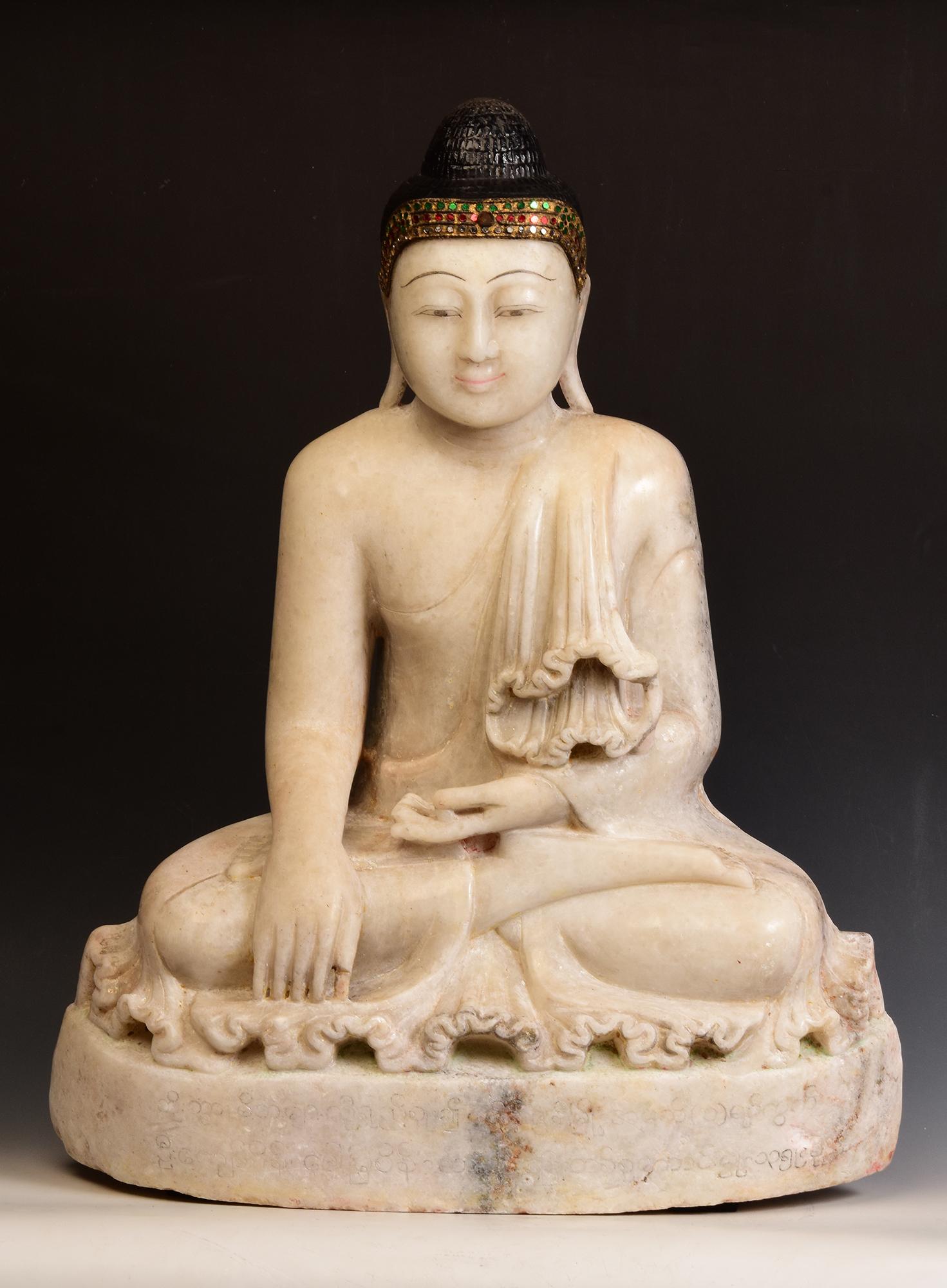 Antique Burmese alabaster Buddha sitting in Mara Vijaya (calling the earth to witness) posture on a base, with inlay of colorful glass pieces on the headband.

Age: Burma, Mandalay Period, 19th Century
Size: Height 70.5 C.M. / Width 55.5 C.M. /