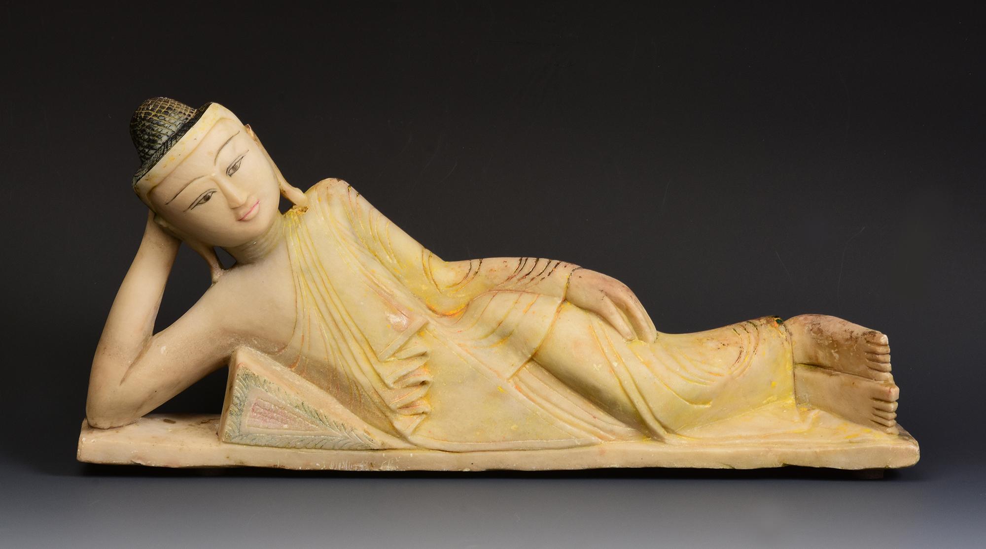 Antique Burmese soapstone reclining Buddha.

Age: Burma, Mandalay Period, 19th Century
Size: Length 43.3 C.M. / Width 6.8 C.M. / Height 19.3 C.M.
Condition: Nice condition overall (some expected degradation due to its age).

100% Satisfaction and