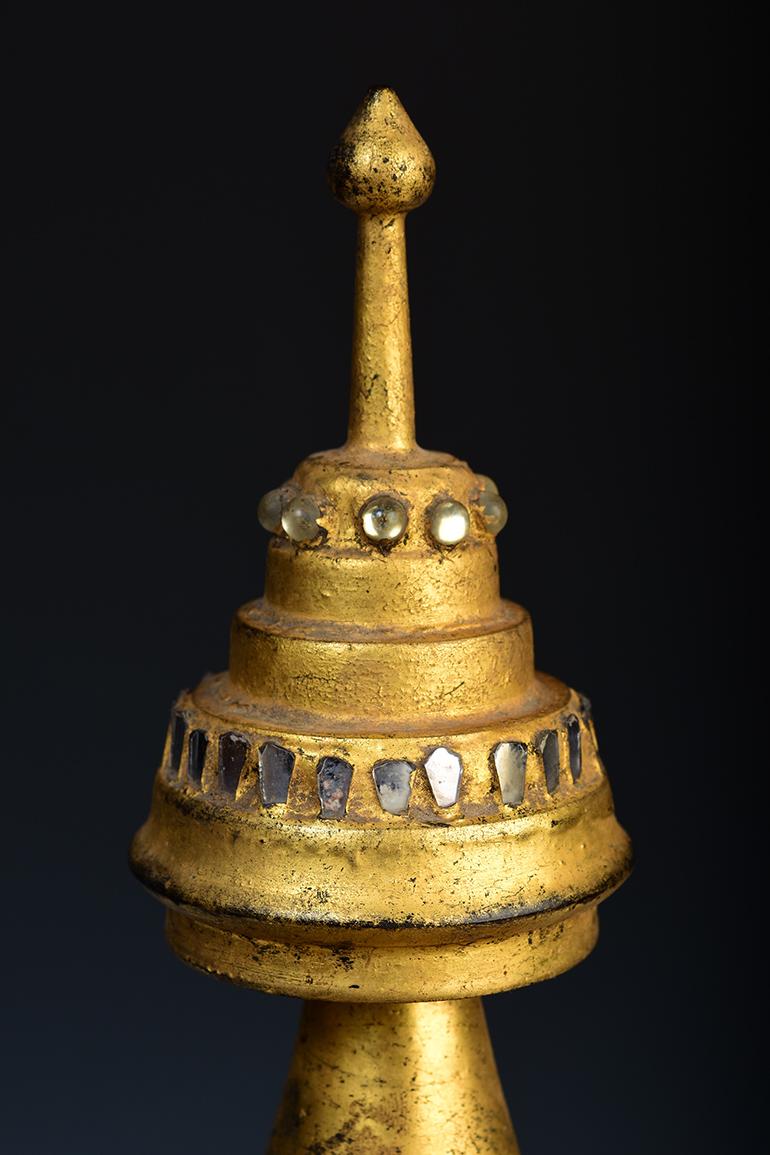 Burmese wooden pagoda with gilded gold.

Age: Burma, Mandalay Period, 19th Century
Size including stand: Height 54.8 C.M. / Width 50.2 C.M. / Length 50.2 C.M.
Condition: Nice condition overall (some expected degradation due to its