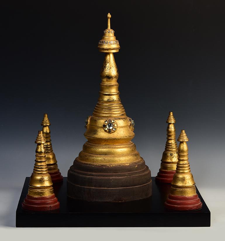 Antique Burmese wooden pagoda with gilded gold.

Age: Burma, Mandalay Period, 19th Century
Size including stand: Height 54.8 C.M. / Width 50.2 C.M. / Length 50.2 C.M.
Condition: Nice condition overall (some expected degradation due to its