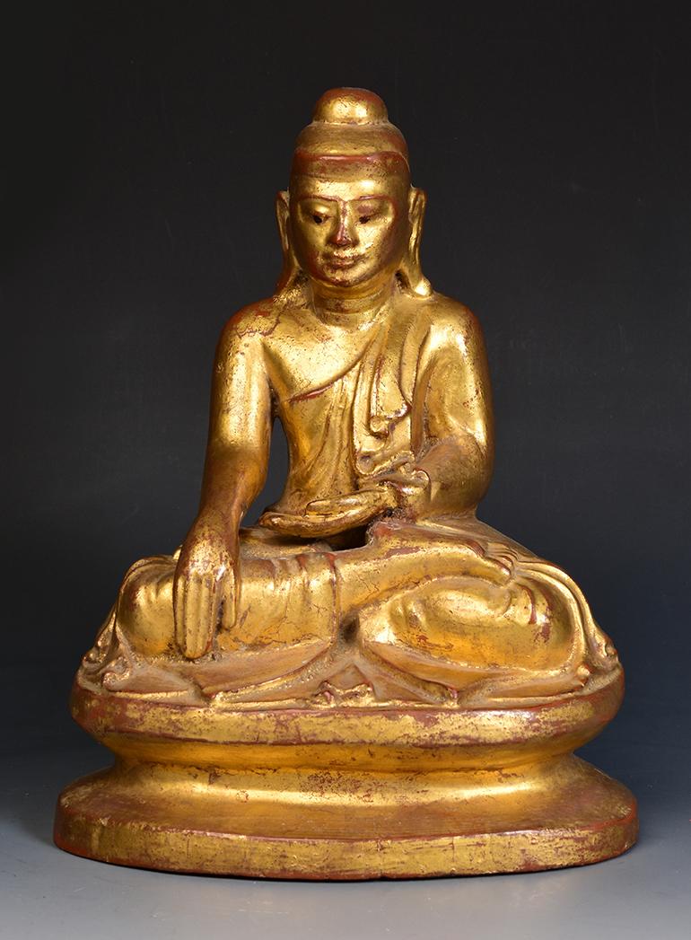 Burmese wooden Buddha sitting in Mara Vijaya (calling the earth to witness) posture on a base, with gilded gold.

Age: Burma, Mandalay Period, 19th Century
Size: Height 25.3 C.M. / Width 20.1 C.M.
Condition: Nice condition overall (some expected