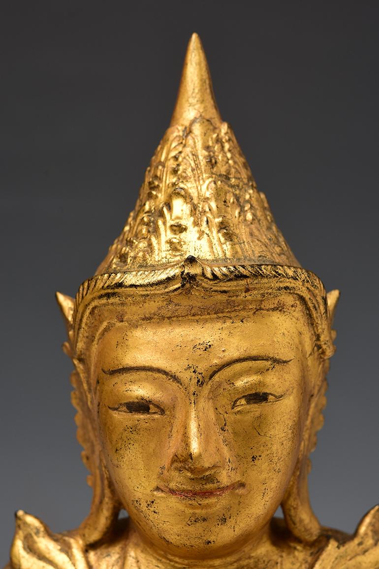 Burmese wooden crowned Buddha with gilded gold or sometimes known as 'King Buddha's, wearing diadem-crowns and ornaments of kings instead of ordinary monk's robes. 

Age: Burma, Mandalay Period, 19th Century
Size: Height 31.8 C.M. / Width 17.4